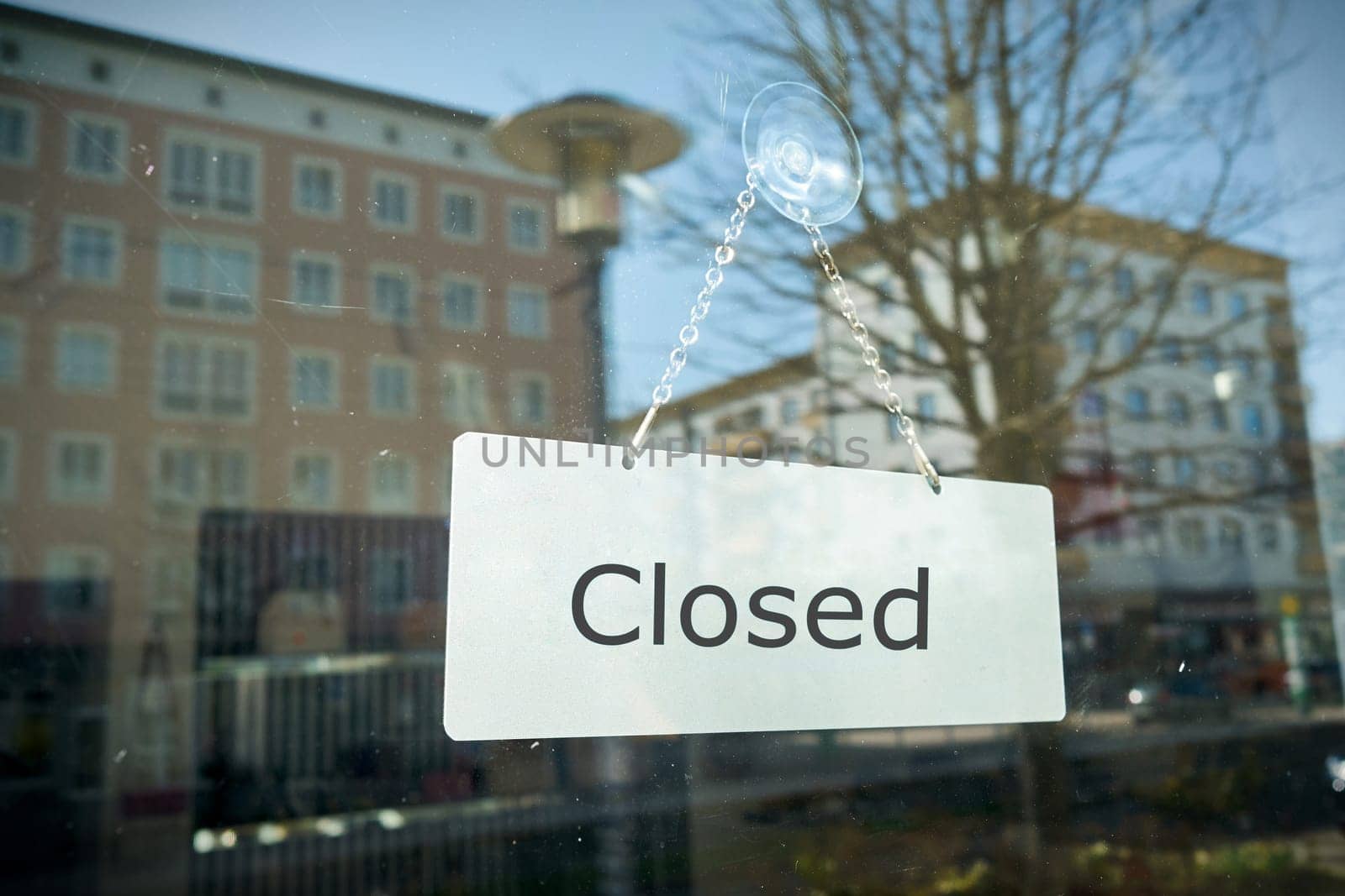 Sign with the inscription "closed"" on the window of a shop"