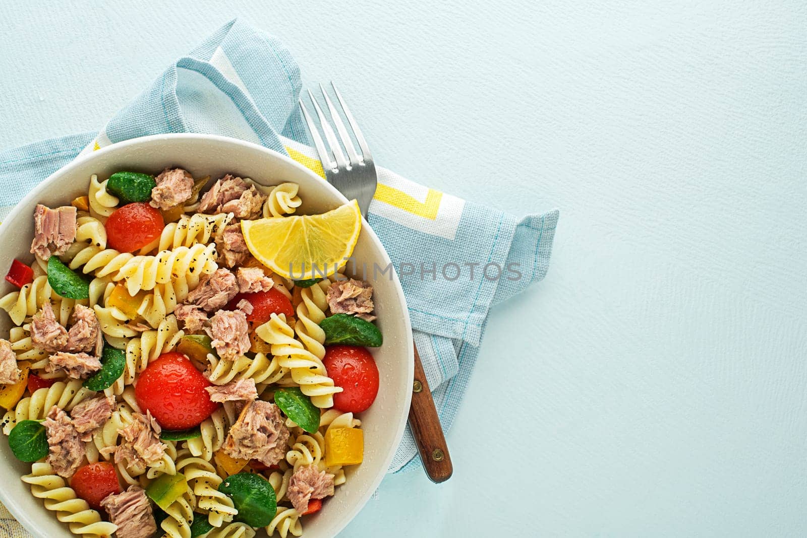 Pasta salad with tuna fish and vegetables. Healthy pasta meal. Seafood.
