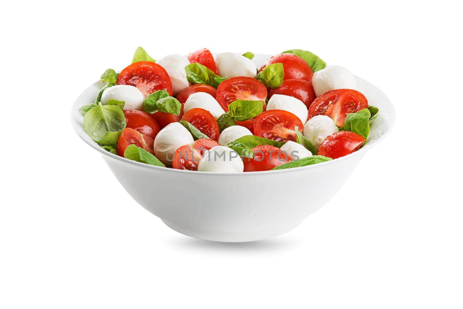 Delicious caprese salad with ripe tomatoes and mozzarella cheese with fresh basil leaves. Italian food.