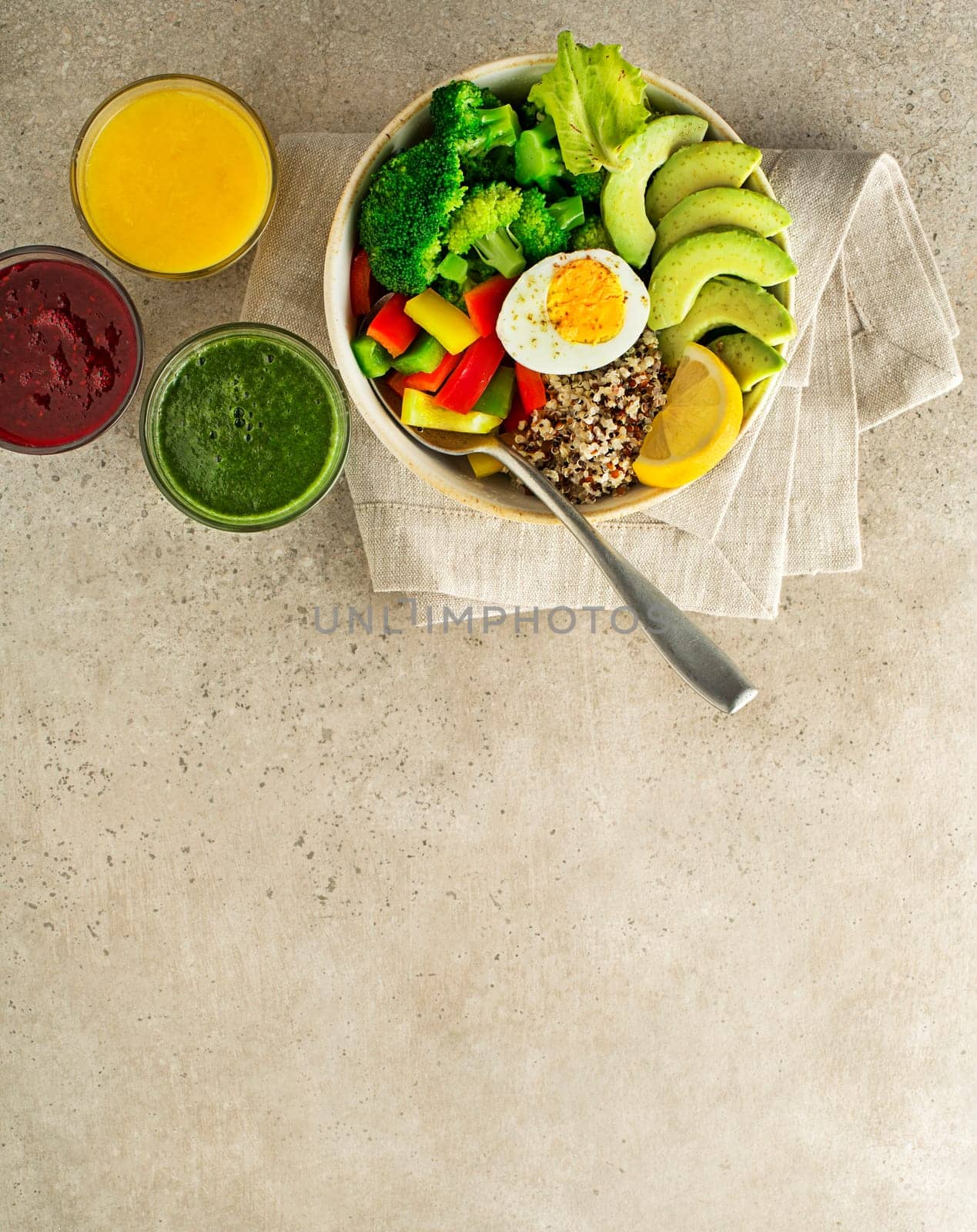 Healthy salad meal with quinoa, egg, avocado and mixed fresh vegetables on grey background top view. Food and health. Healthy meal concept