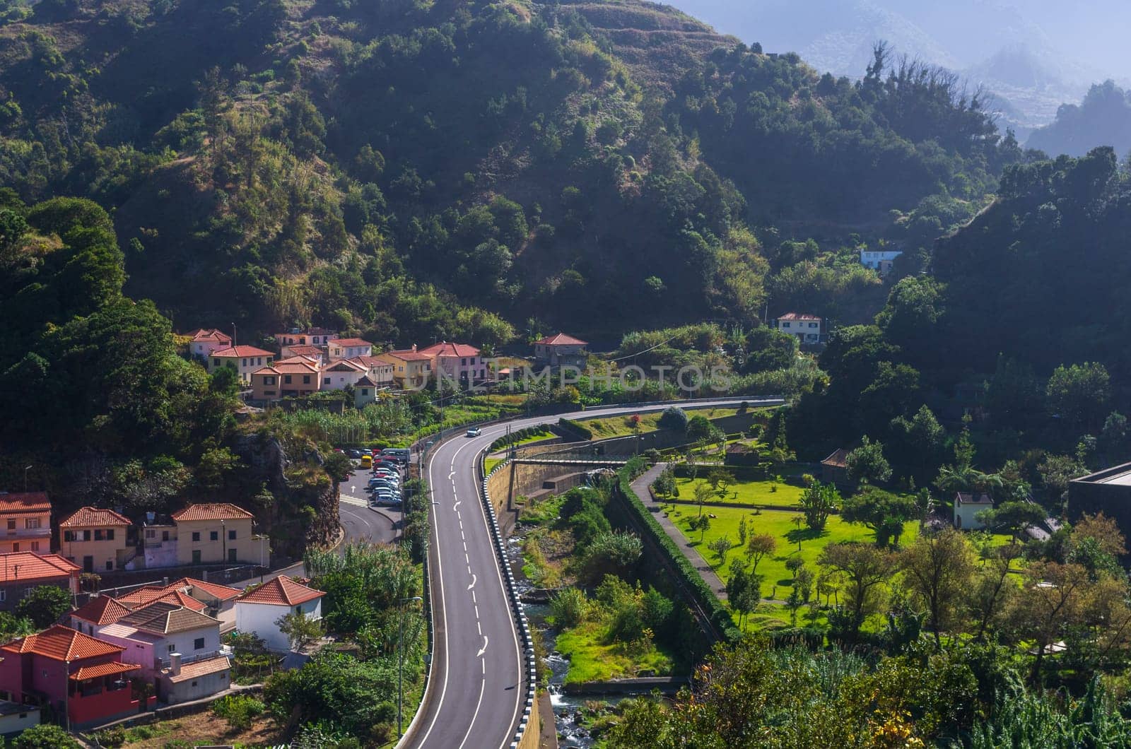 Sao Vicente Madeira Portugal - October 30 2019: The main street, chanal and houses by the mountain.