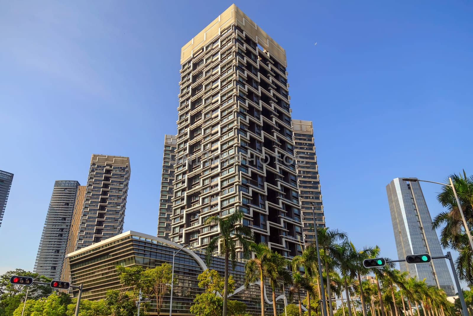 High-rise buildings in the city in clear sunny weather with tropical greens, Shenzhen, China, Asia
