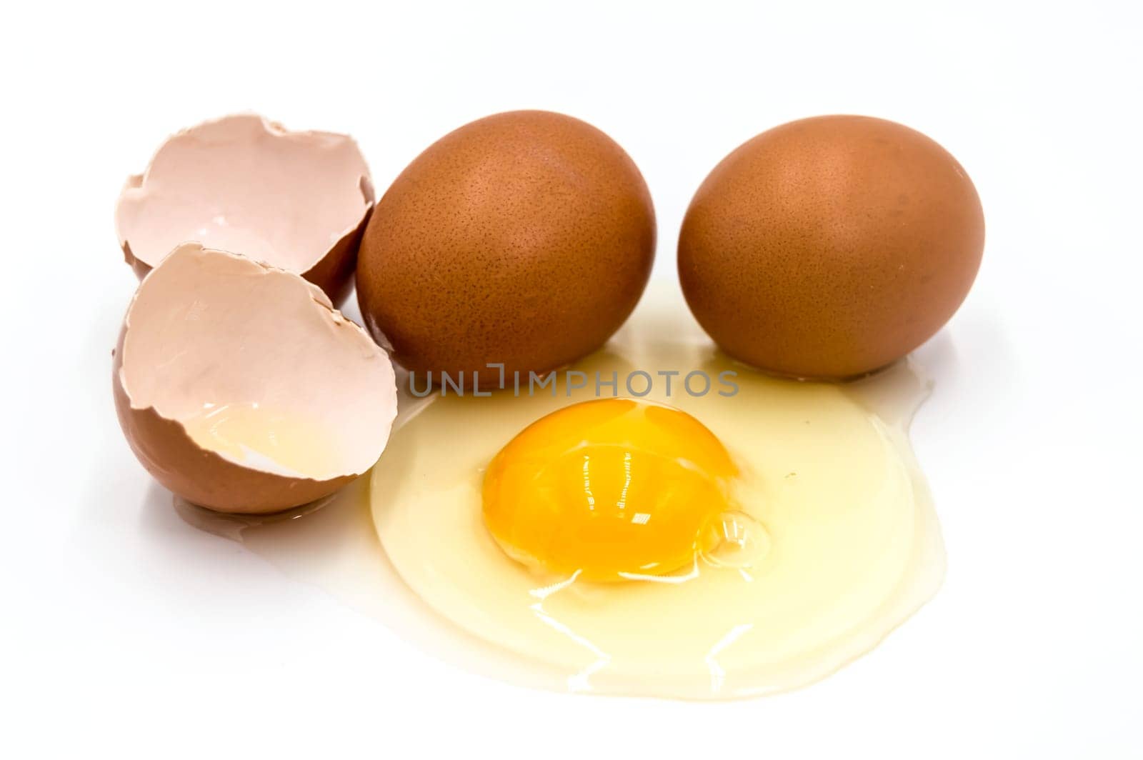 Egg yolk and white on white background