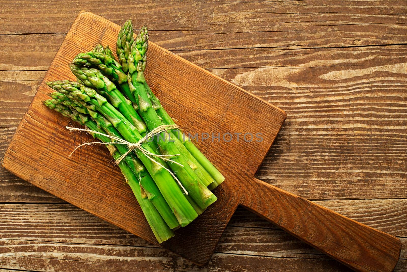 Asparagus. Fresh Asparagus. Pickled Green Asparagus. Bunches of green asparagus on wooden table, top view- Image