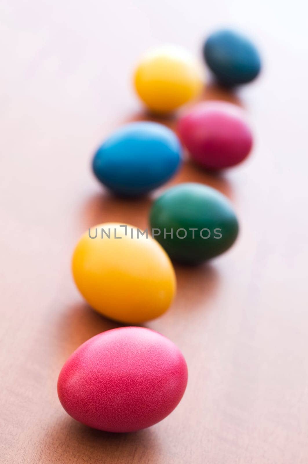 Colorful Easter eggs on wooden table background close up