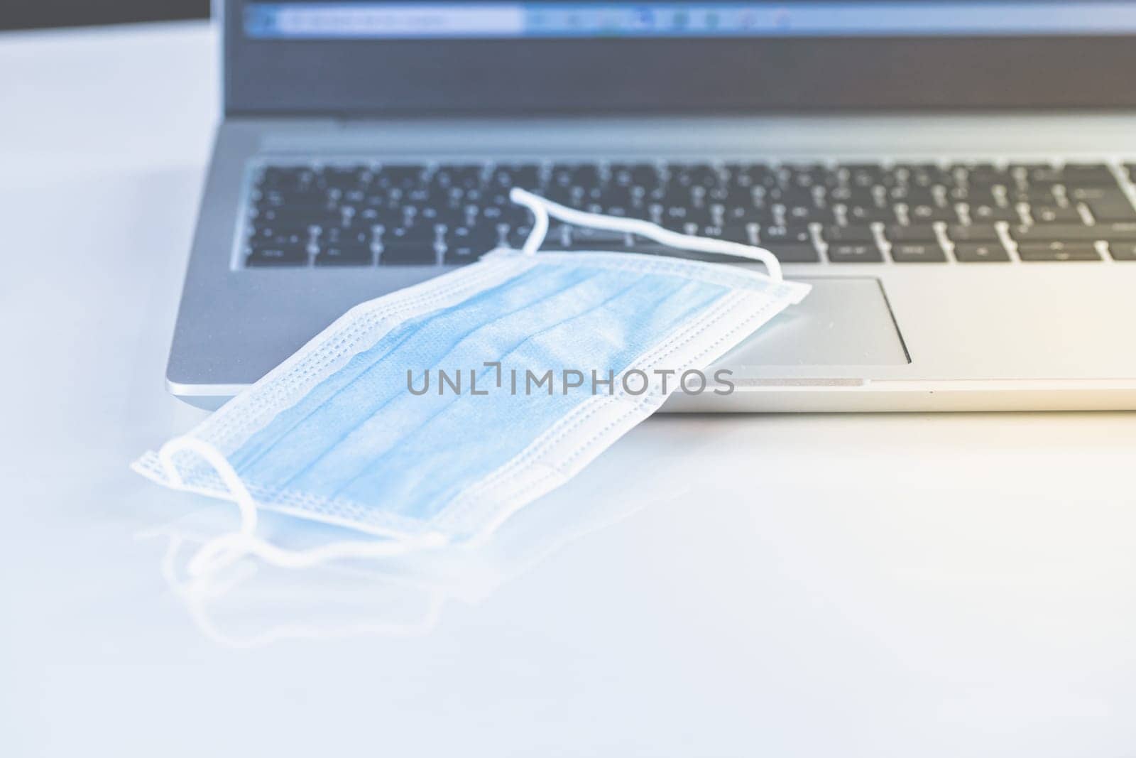Home Office Medicine - PC with mask, stethoscope for protection against virus, infection, diagnosis and documentation.
