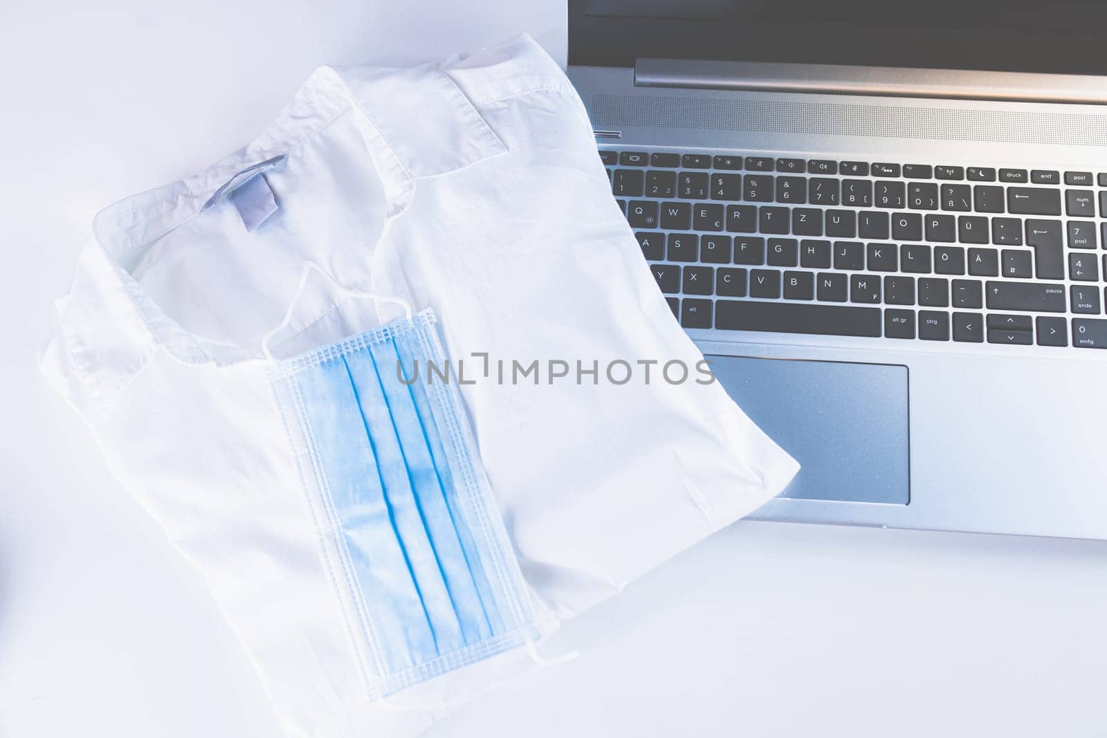 Home Office Medicine - PC with mask, stethoscope for protection against virus, infection, diagnosis and documentation.