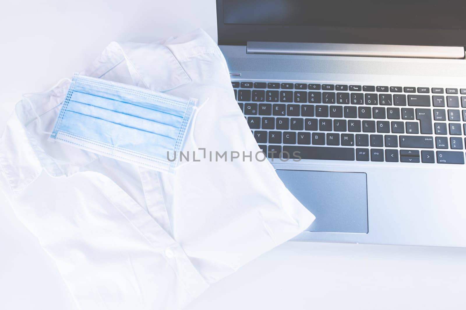Home Office Medicine - PC with mask, stethoscope for protection against virus, infection, diagnosis and documentation.