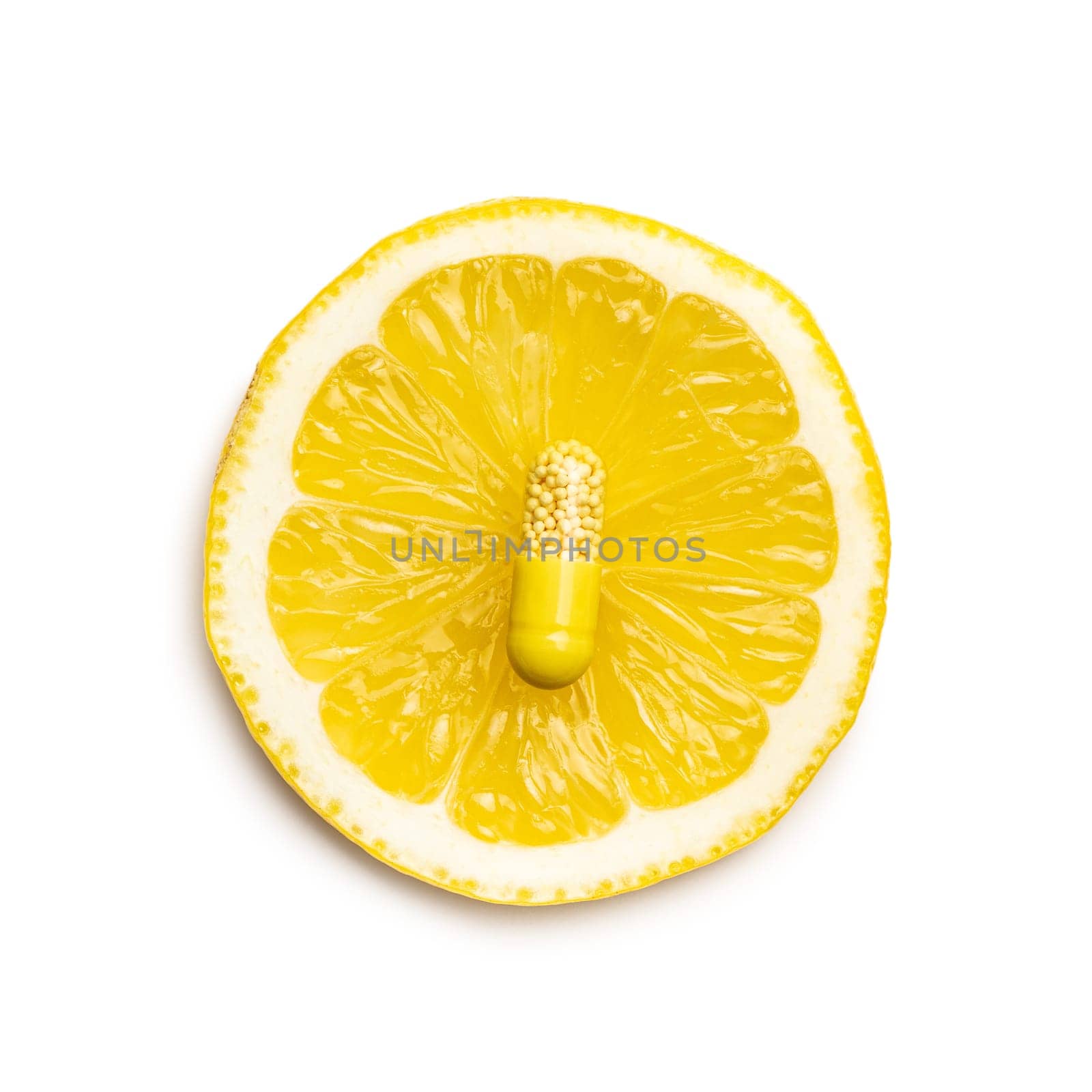 Vitamin capsules. Vitamin C pills and slice of lemon isolated on white background. Top view.