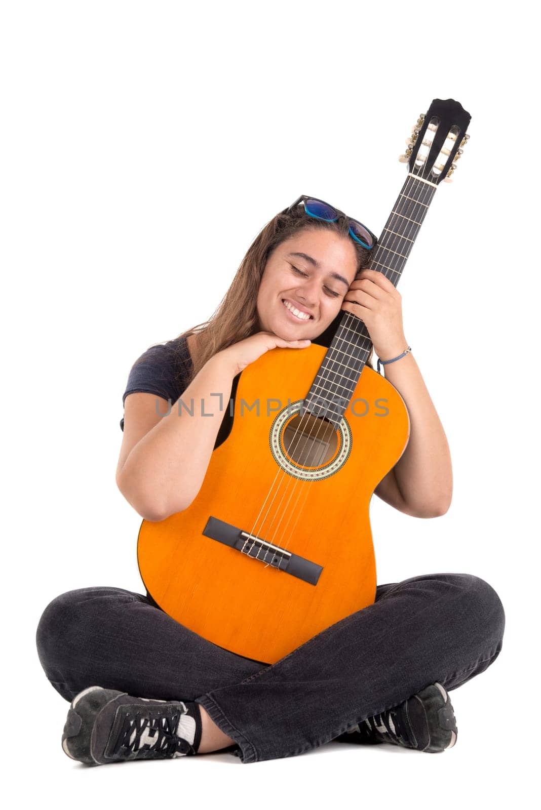 Happy girl posing with guitar, isolated in white