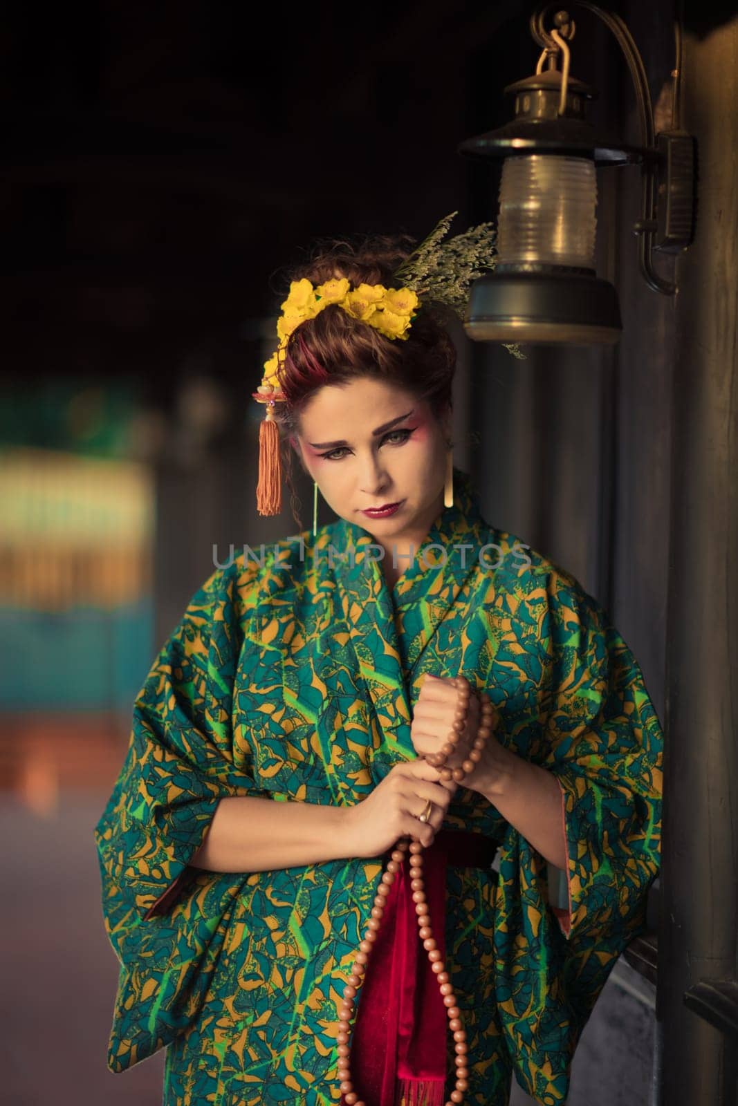 Fine art portrait of beautiful woman in Japanese Geisha style wearing kimono