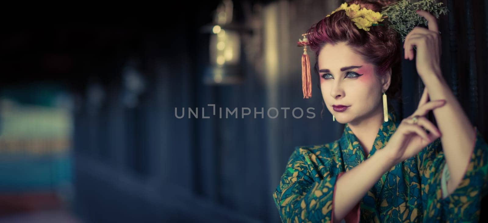 Fine art portrait of beautiful woman in Japanese Geisha style wearing kimono. Panorama
