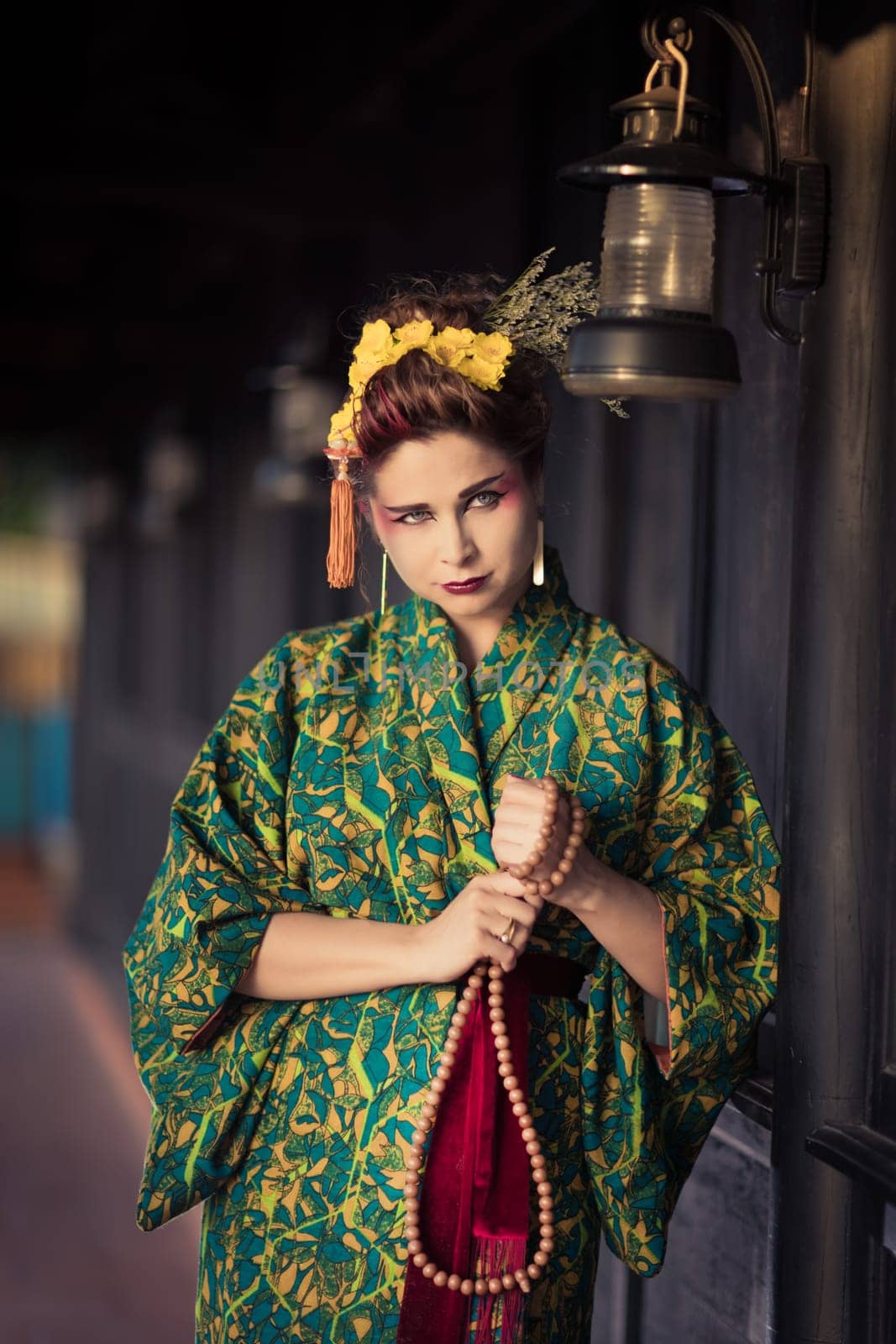 Fine art portrait of beautiful woman in Japanese Geisha style wearing kimono