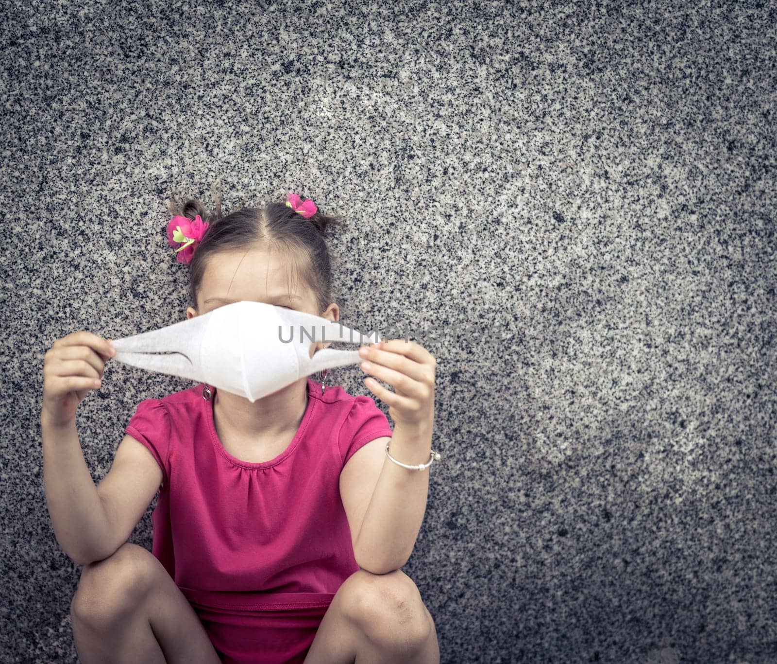 Girl wearing facial disposable mask to avoid viral infection. Virus protection