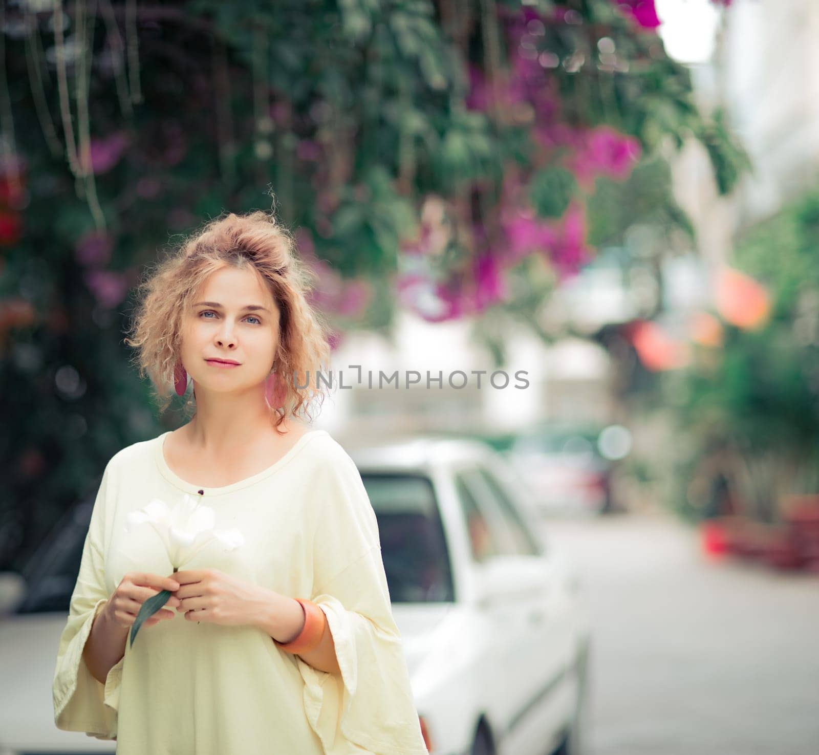 Outdoor portrait of a beautiful woman with flower