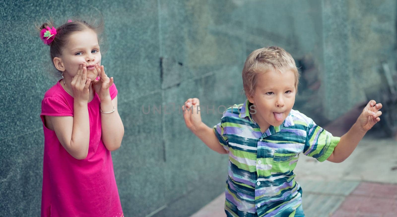 Boy and girl doing funny faces outdoor