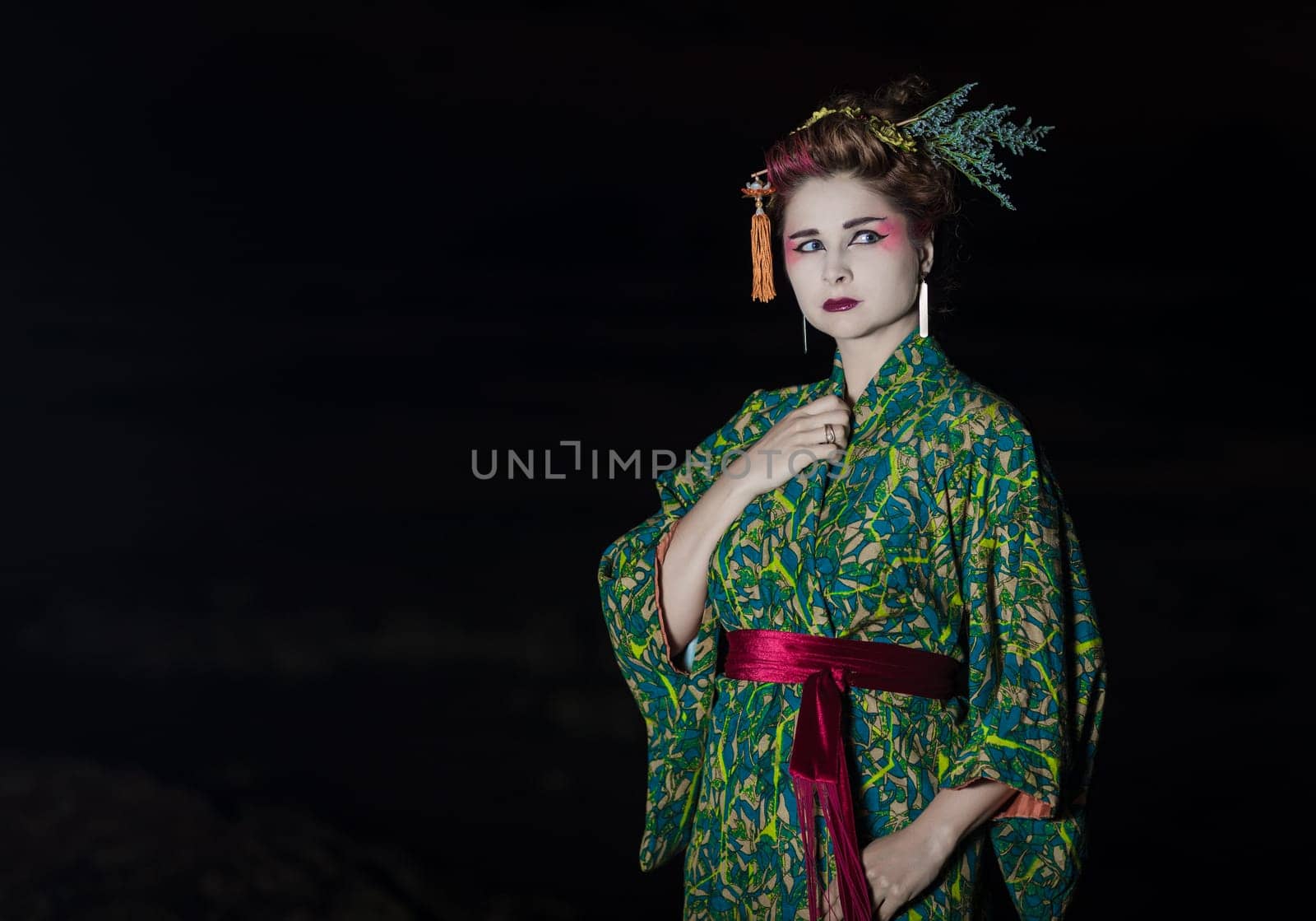 Fine art portrait of european woman in Japanese Geisha style wearing kimono