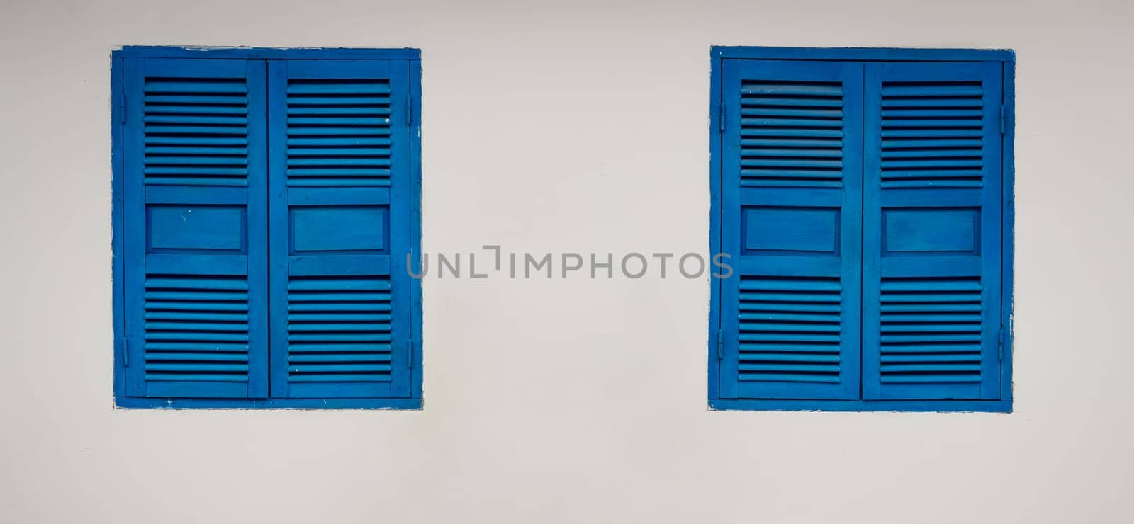 White wall with closed shatter windows