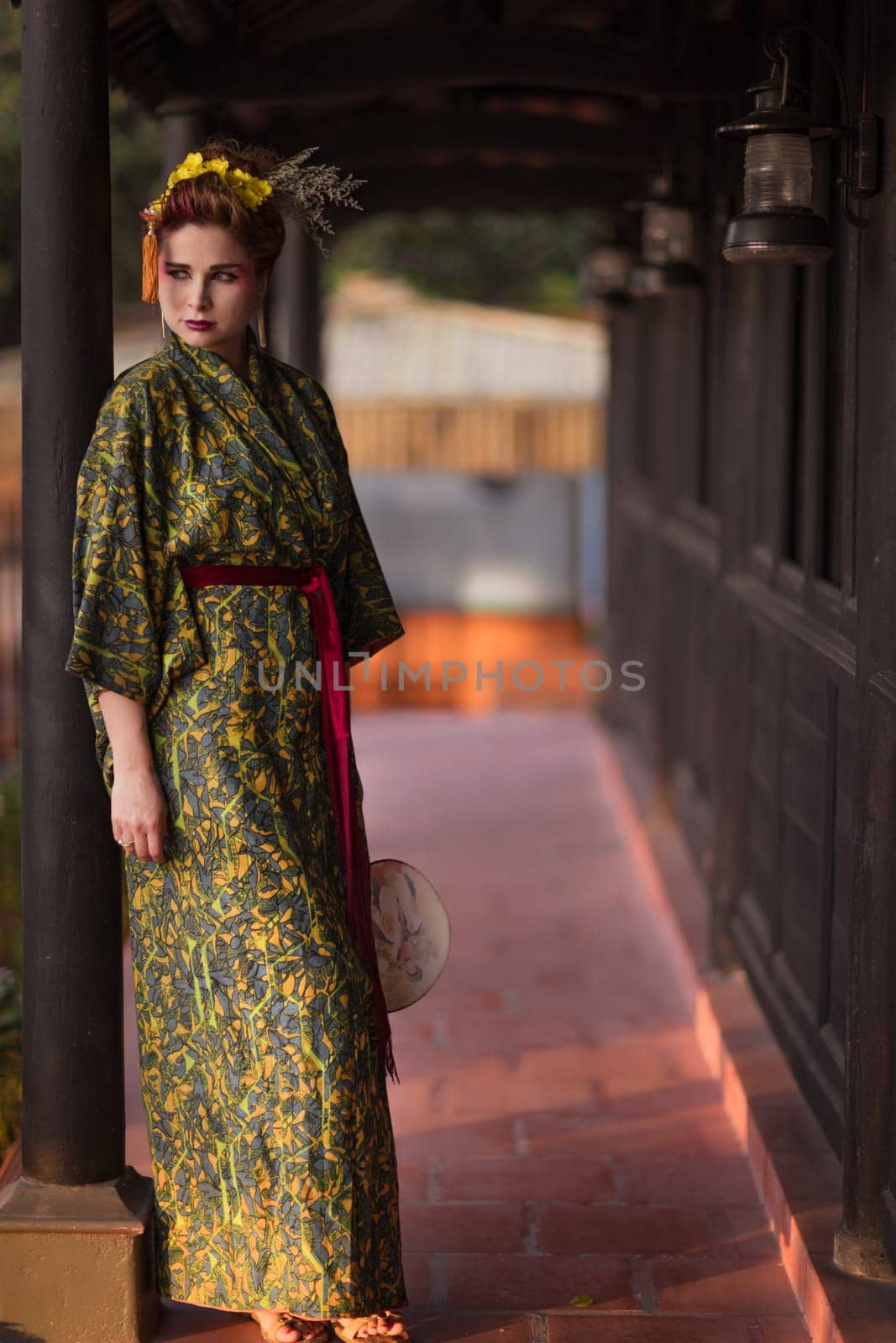 Fine art portrait of beautiful woman in Japanese Geisha style wearing kimono