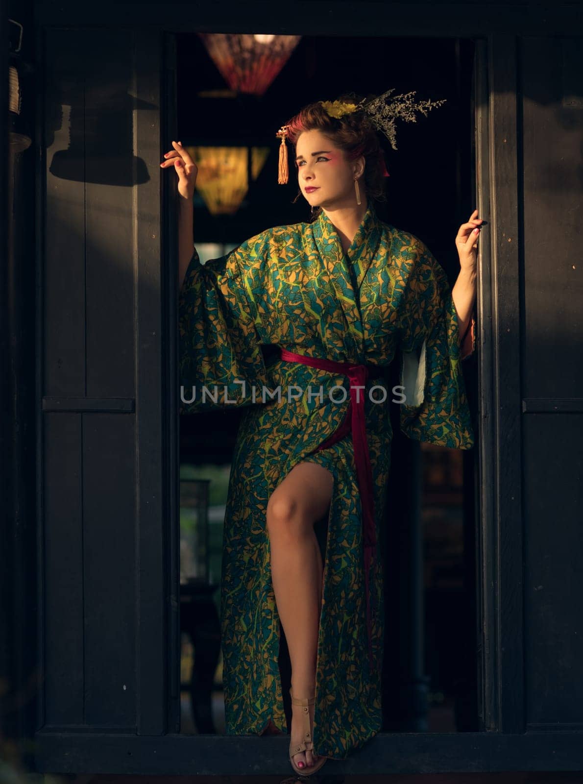 Fine art portrait of beautiful woman in Japanese Geisha style wearing kimono
