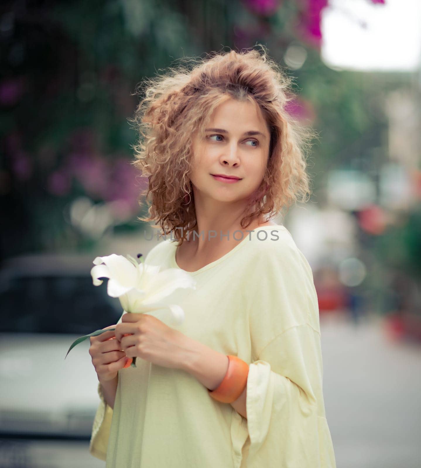 Outdoor portrait of a beautiful woman with flower