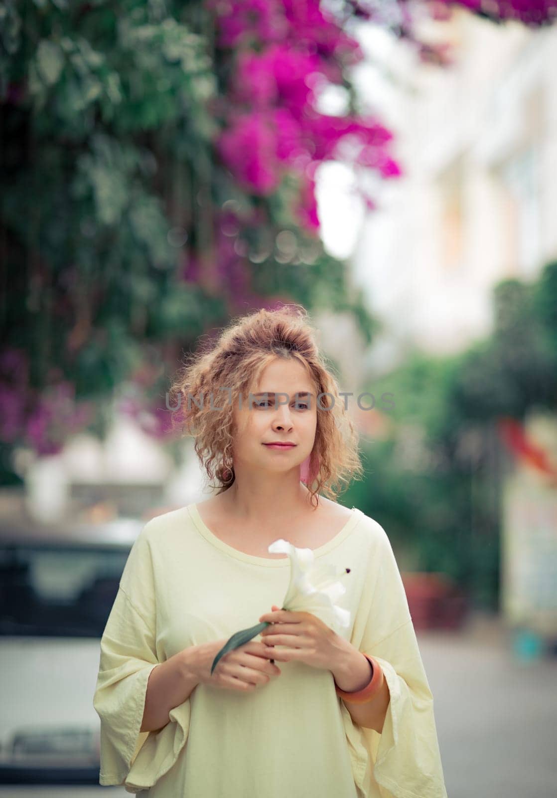 Outdoor portrait of a beautiful woman with flower