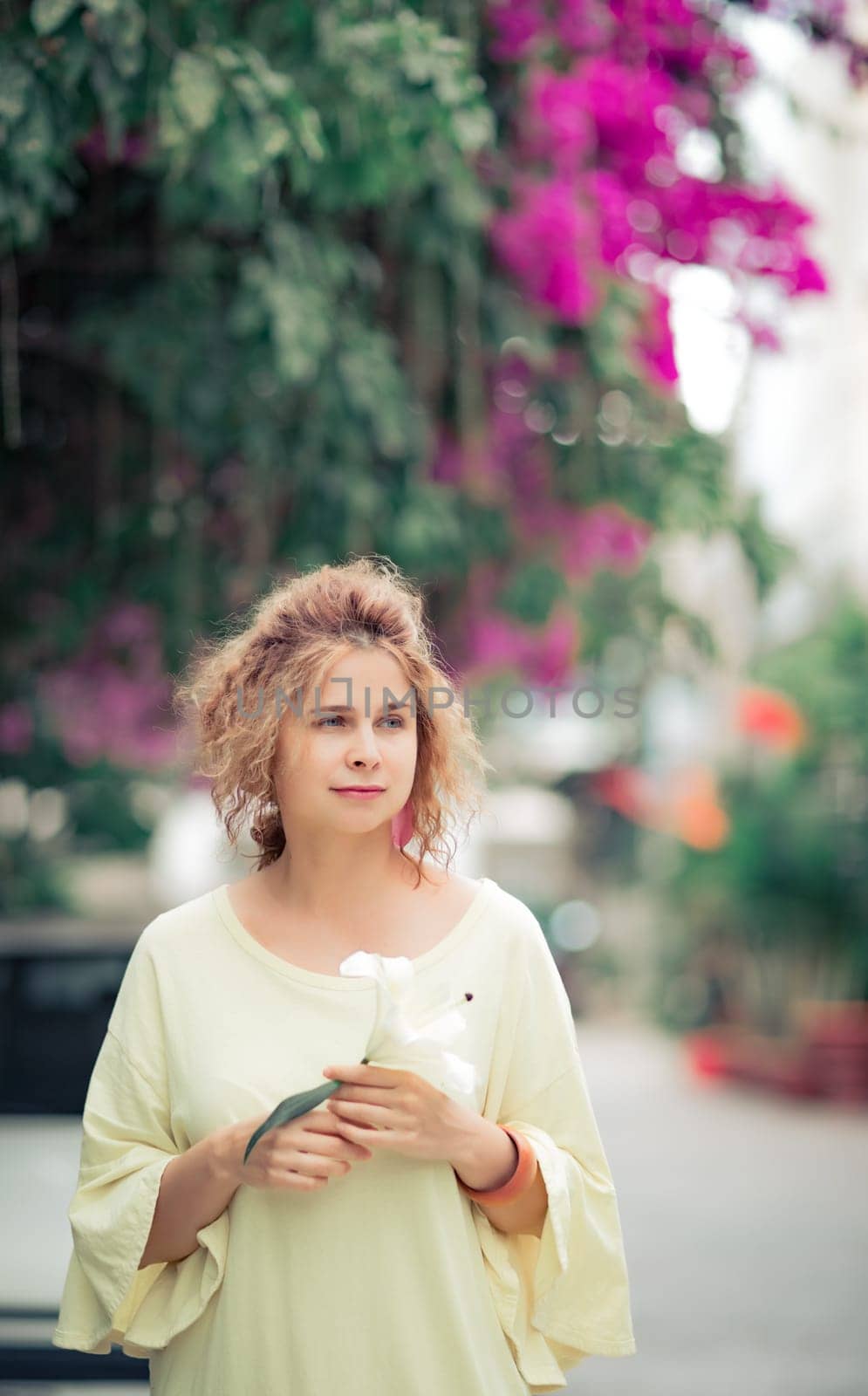 Outdoor portrait of a beautiful woman with flower