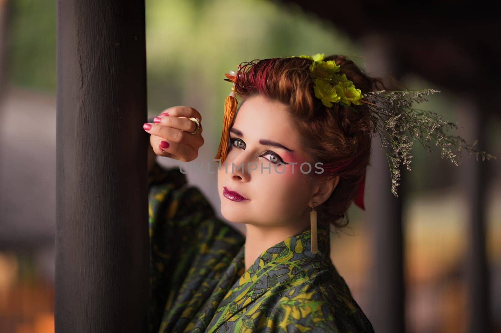Fine art portrait of beautiful woman in Japanese Geisha style wearing kimono