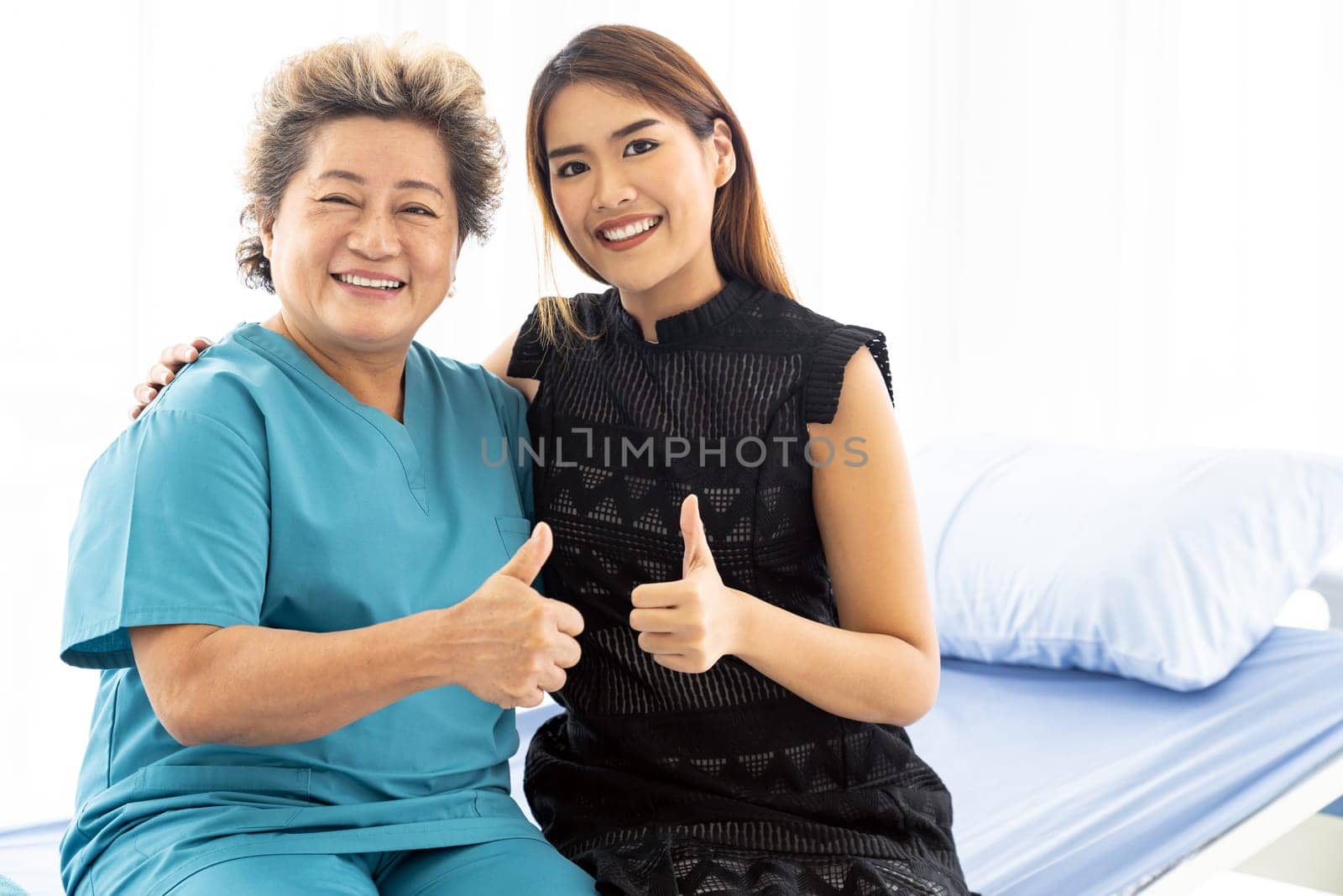Cute young daughter embracing hug her happy old elderly mother with love at home