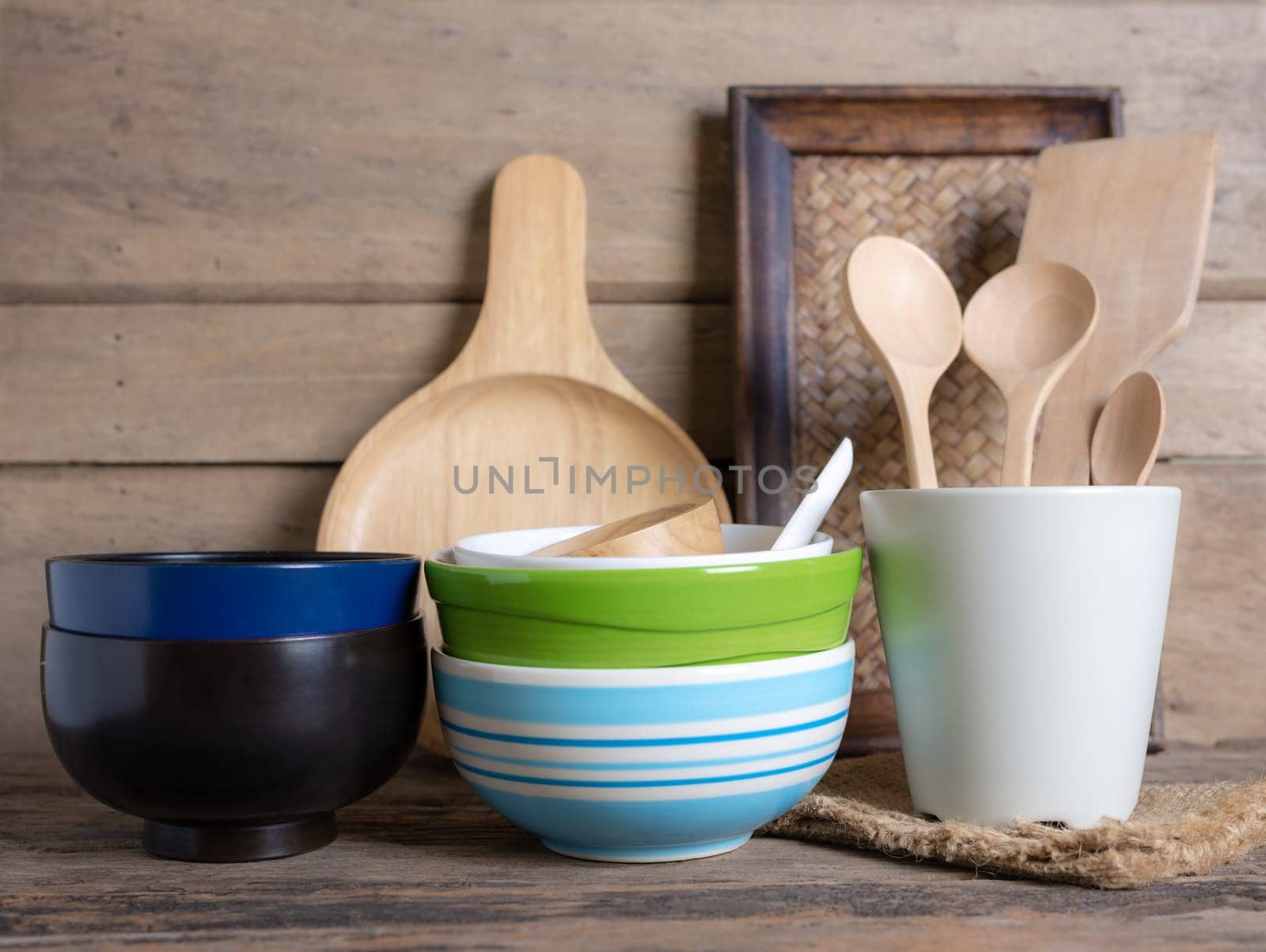 Rustic kitchenware against white wooden wall, Ceramic pot with wooden cooking utensil set