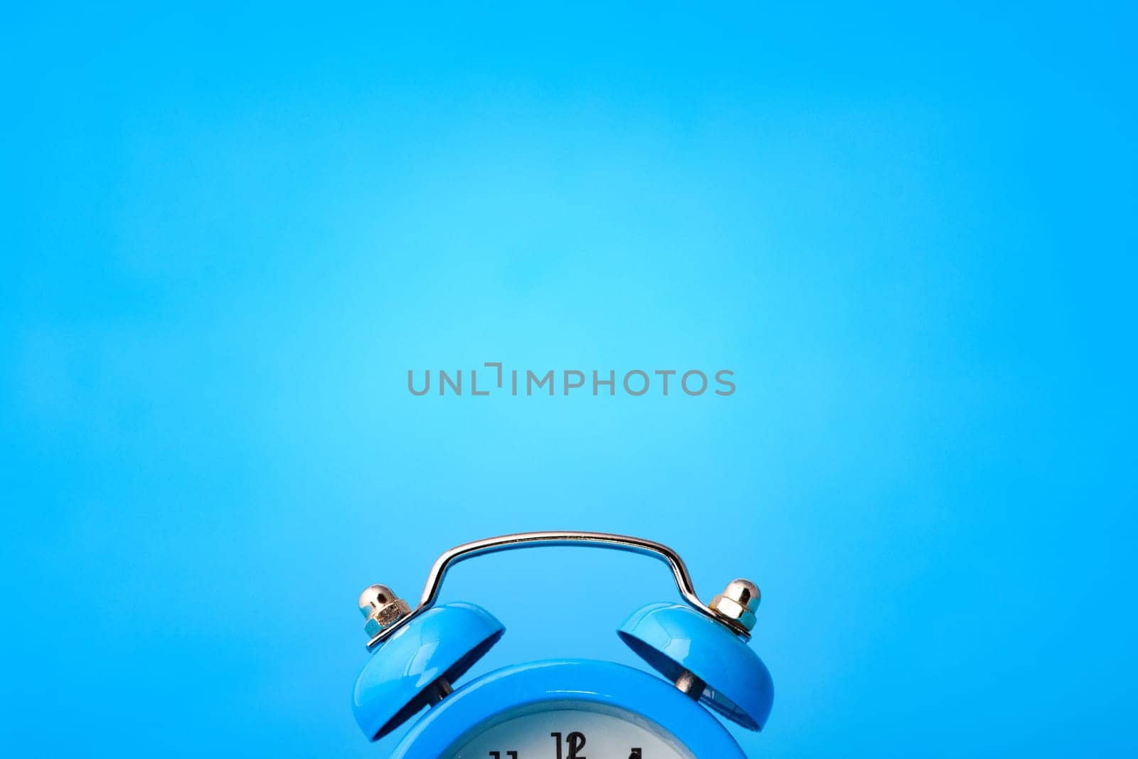Close-up of an alarm clock, above it an empty place
