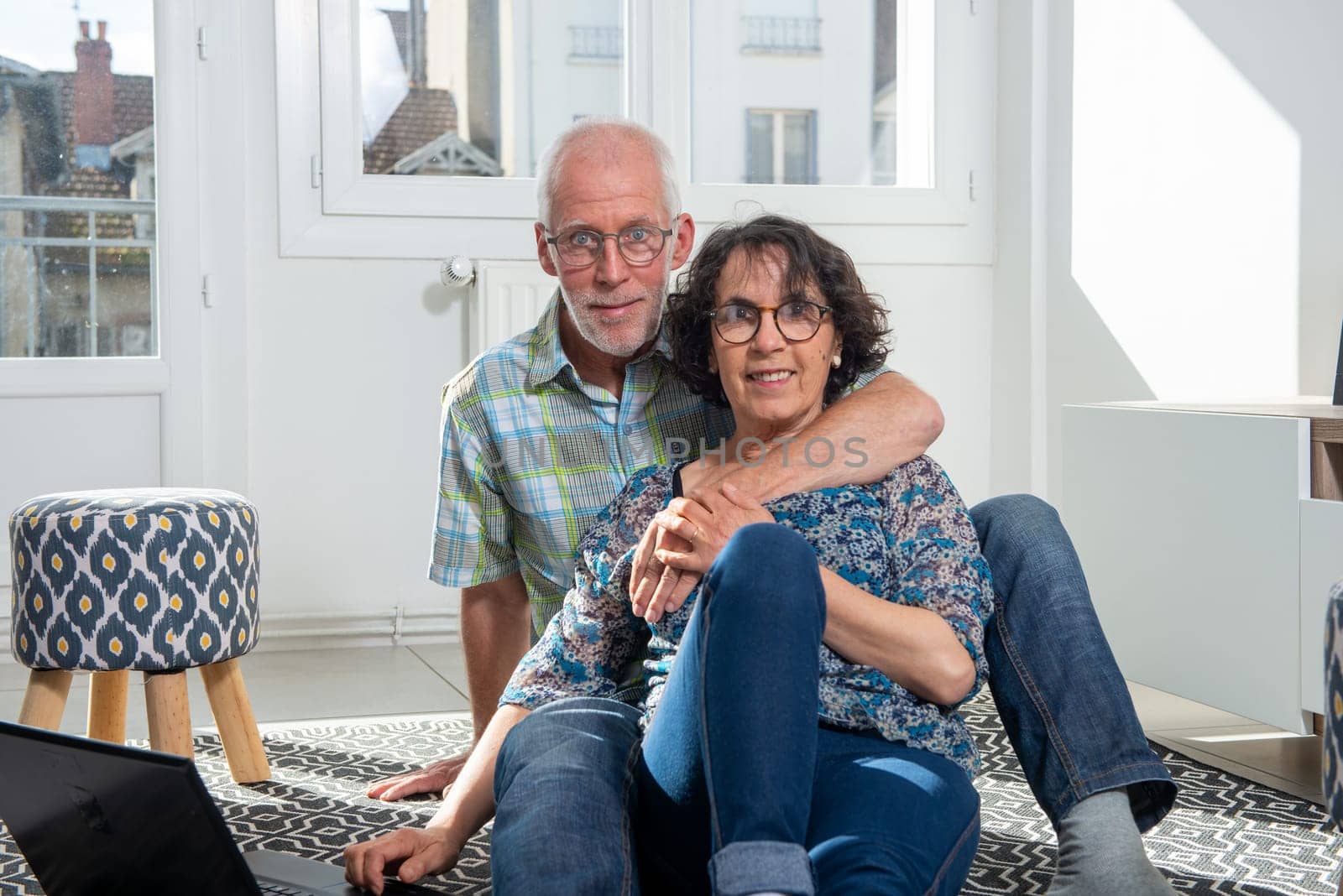 happy senior couple in a living room