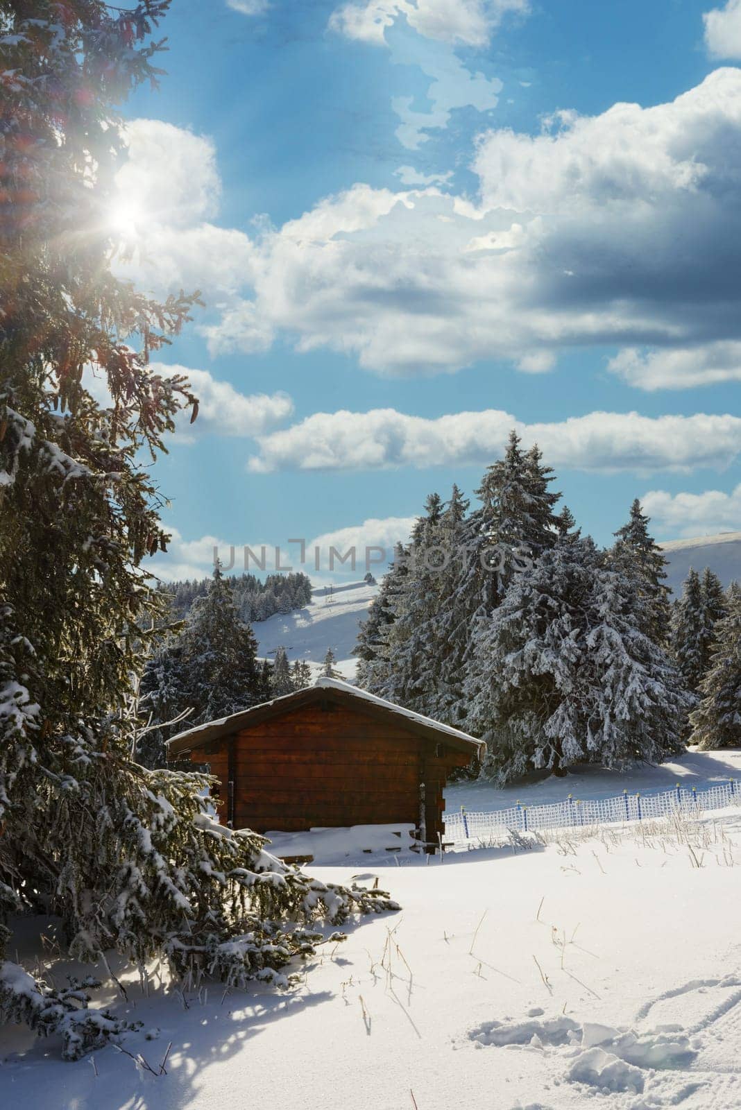 a winter landscape with a small chalet