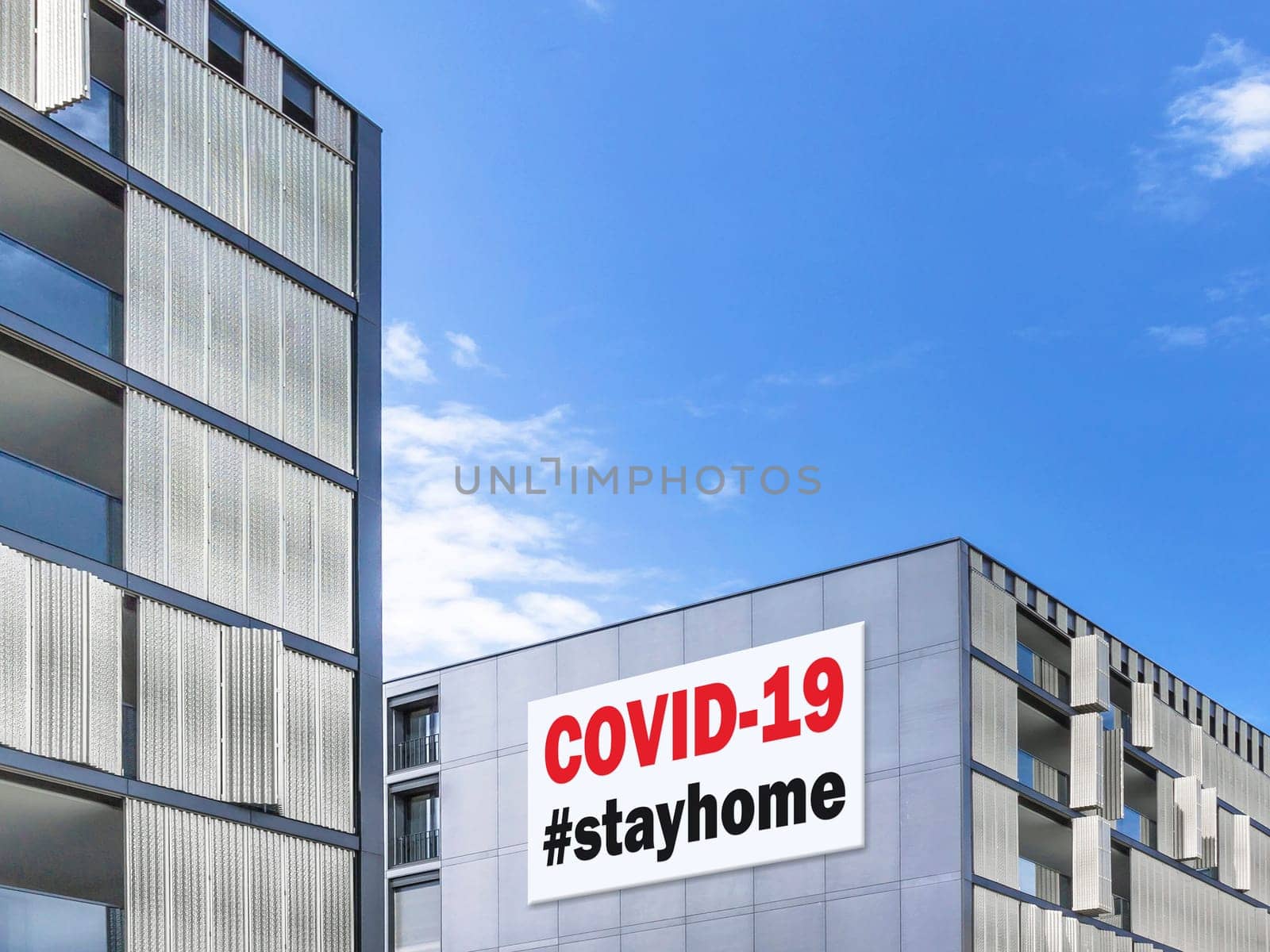 Modern cityscape with hastag #stayhome (COVID-19) on a building facade. Coronavirus in Italy. COVID-19 alert banner. 2019 Coronavirus concept, for an outbreak occurs in Wuhan - China.