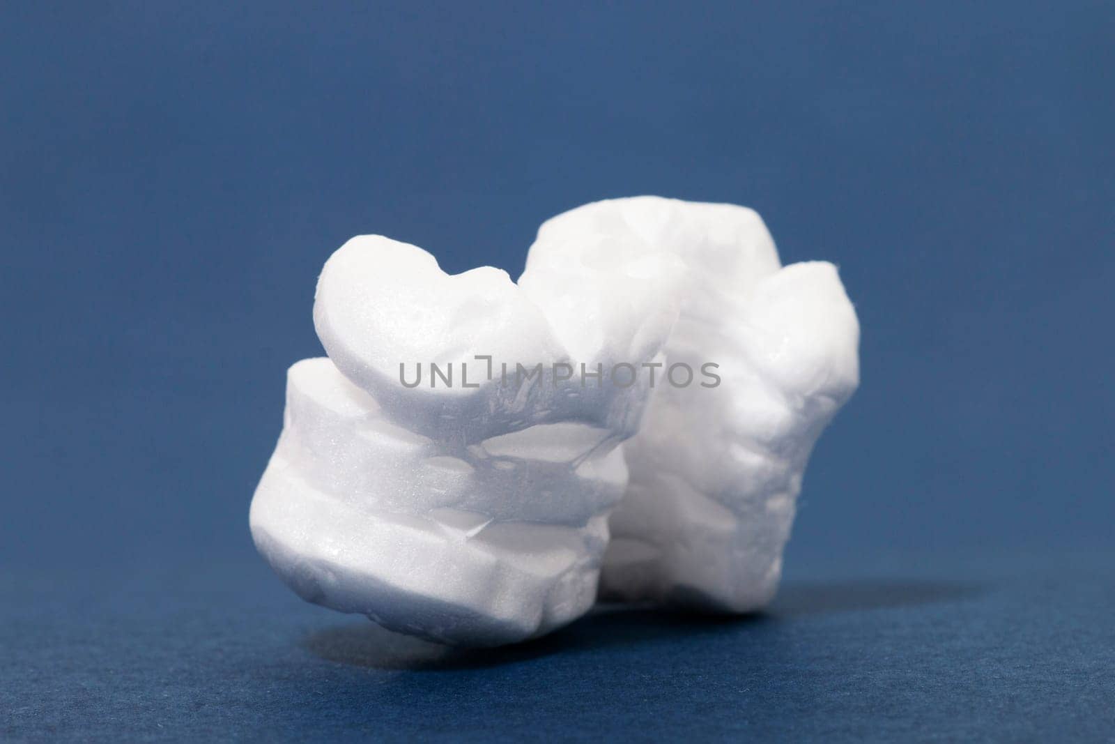 Polystyrene or white styrofoam packing pieces used for minimize bumps in transportation of goods.