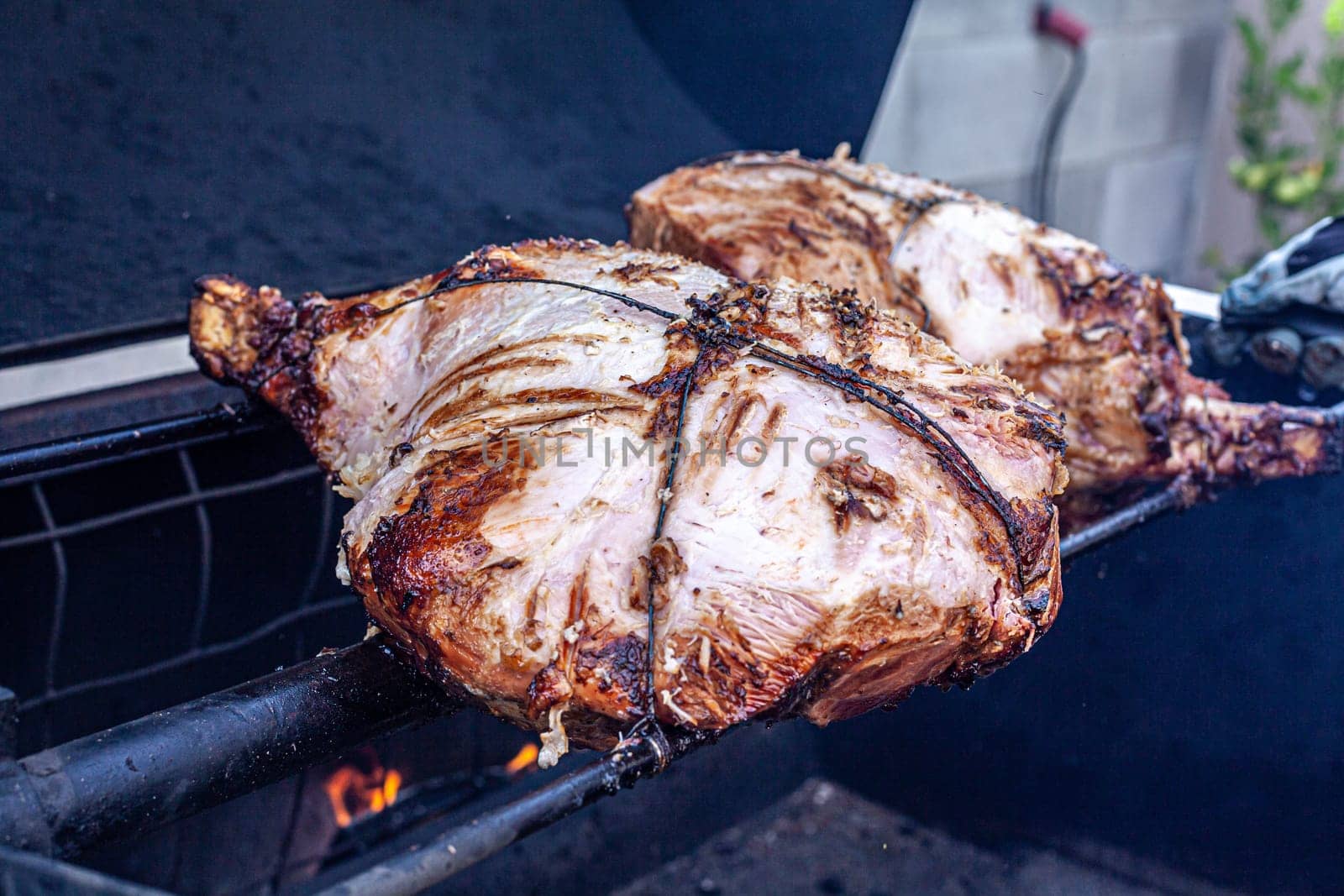 A big piece of pork meat on a grill - Apork leg