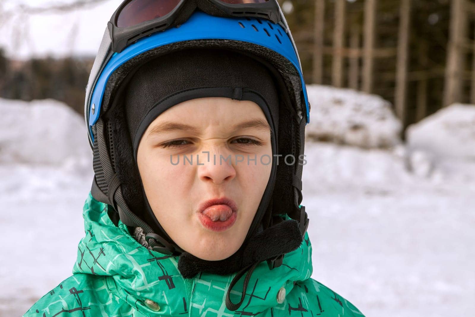 little boy on mountains in ski helmet with fallen first tooth, Czech Republic