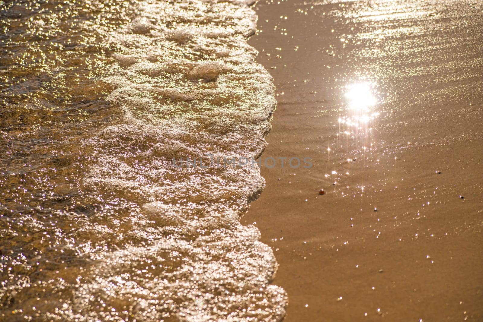 surf of the Baltic sea with evening sun