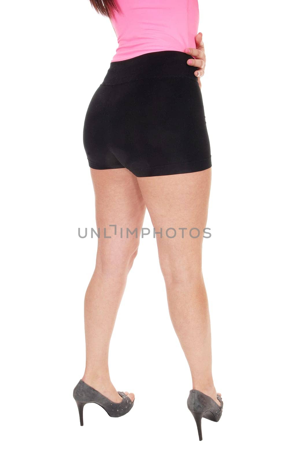 A young beautiful woman standing from the back in black shorts.in body part, showing her nice figure, isolated for white background.