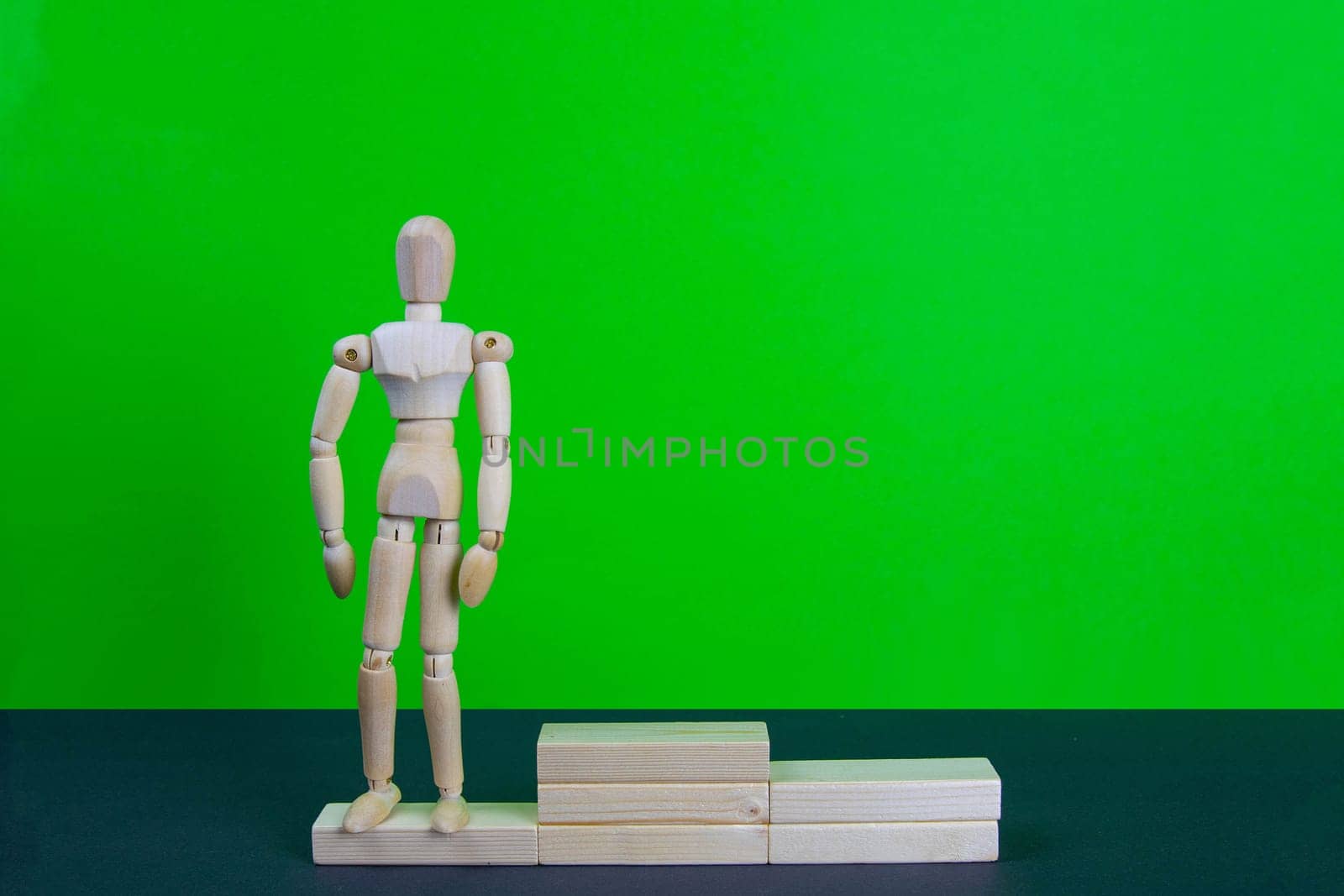 Full length portrait of male winner on winner's pedestal, on green background. The composition of 3 components: 3 place.