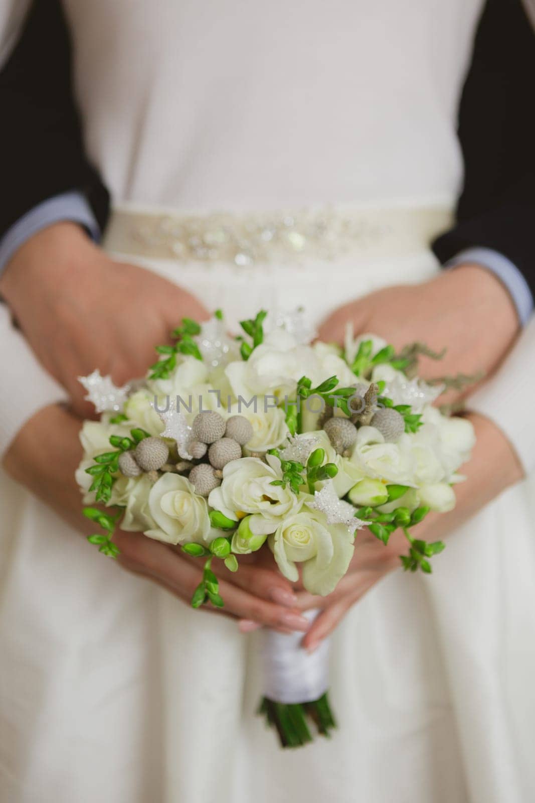 Elegant bride and groom posing together in studio on a wedding day