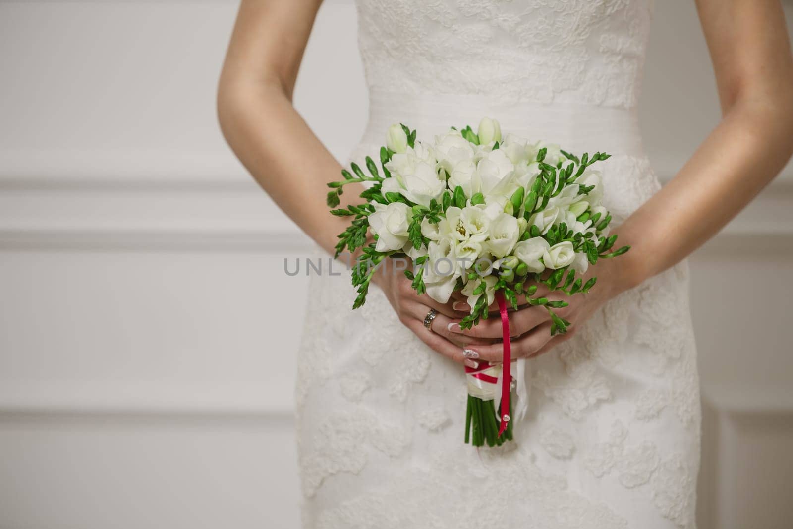 Beautiful wedding bouquet in hands of the bride