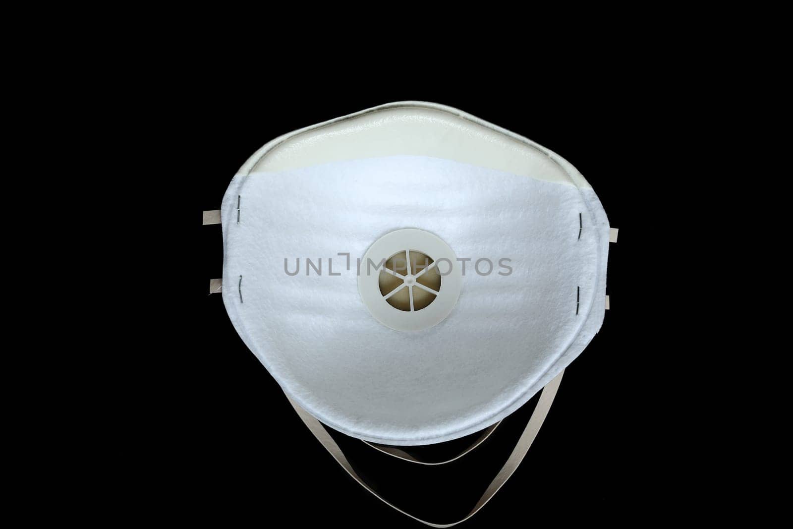 Protection White Surgical Mask FFP2 To Protect Against Virus Infection Coronavirus COVID-19, Isolated On Black Background