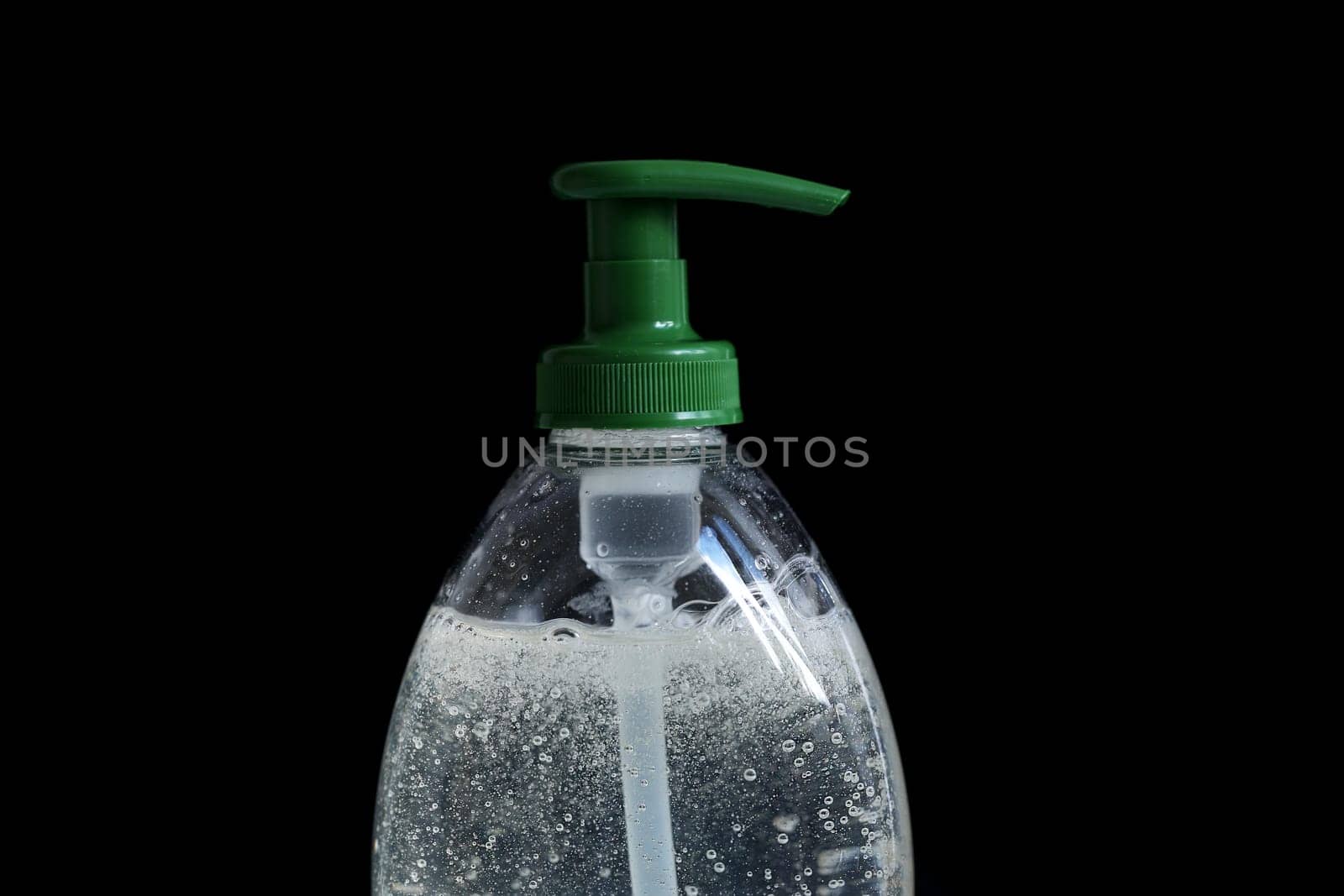Hand-Washing To Prevent Coronavirus (COVID-19) Concept, Rising Soap Bubbles In Pump Plastic Bottle On The Black Background. Close Up View / Macro Shot