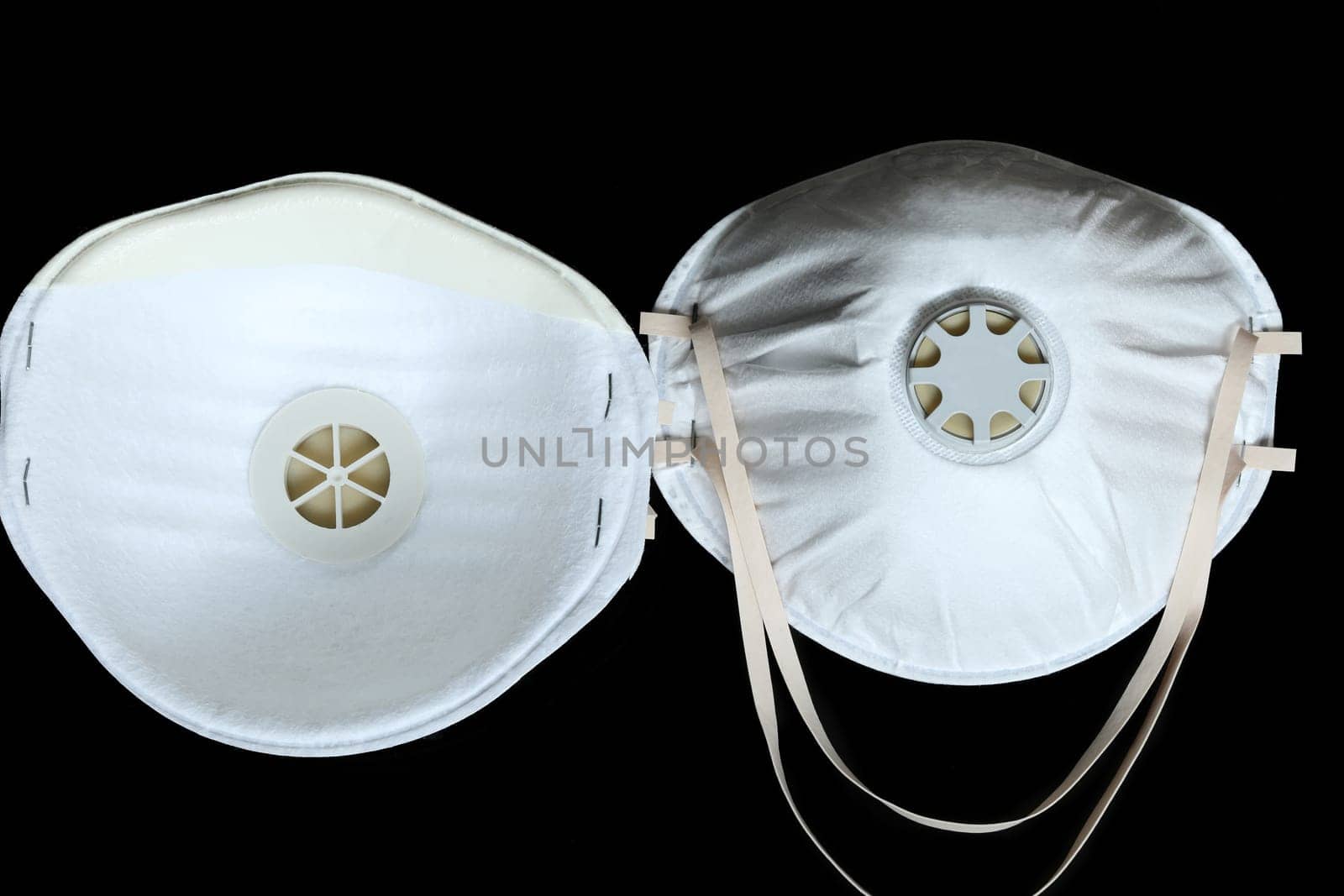 Two Protection White Surgical Masks FFP2 To Protect Against Virus Infection Coronavirus COVID-19, Isolated On Black Background