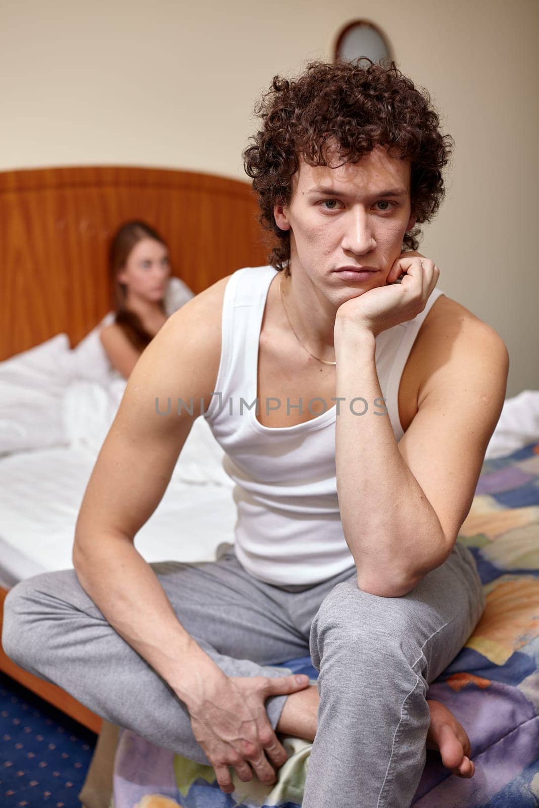 Family problems. Young couple quarrels in bedroom at home. Family conflict. Selective focus on man