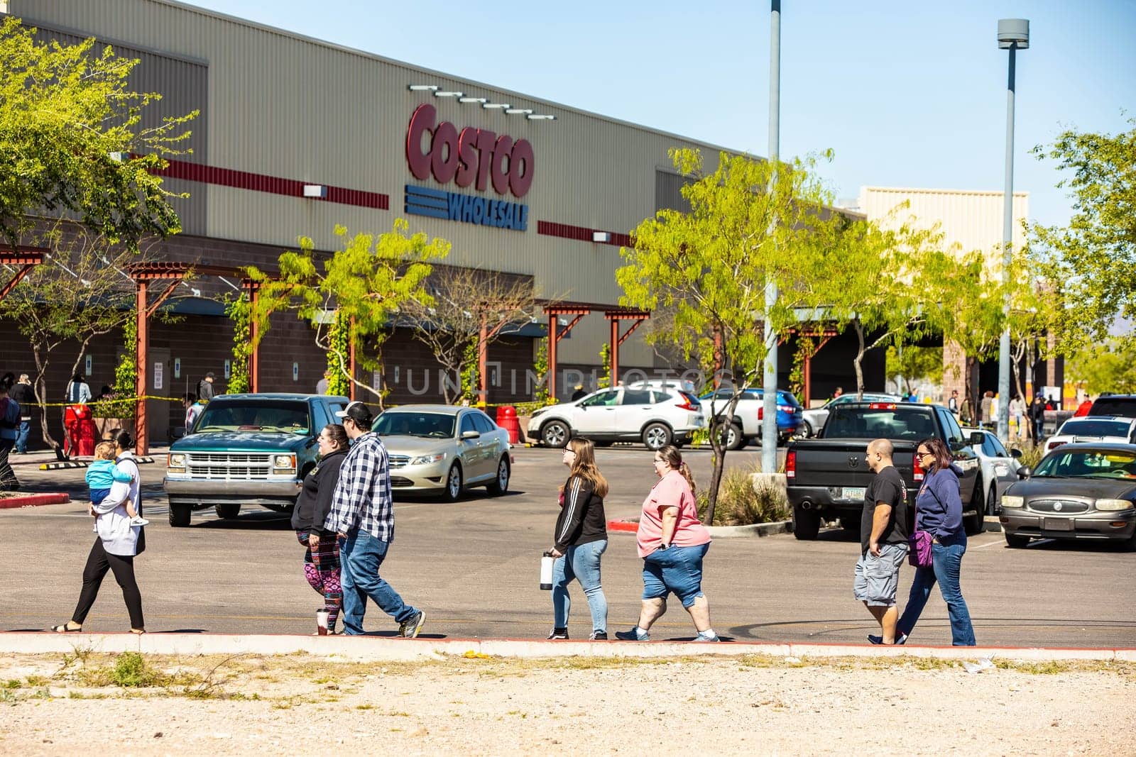 TUCSON, UNITED STATES  - March 29: Shoppers practicing social distancing lined up outside Costco store in Tucson during the coronavirus pandemic.. March 29, 2020 in Tucson, Arizona, USA.