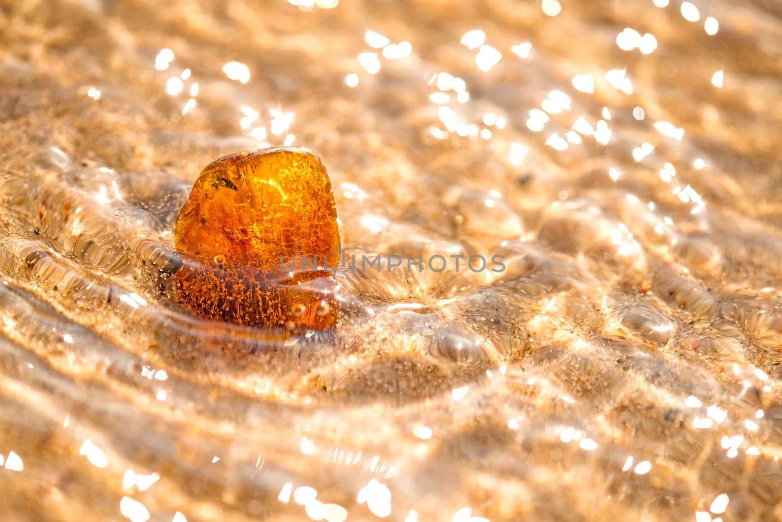 Amber on a beach of the Baltic Sea in the surf.
