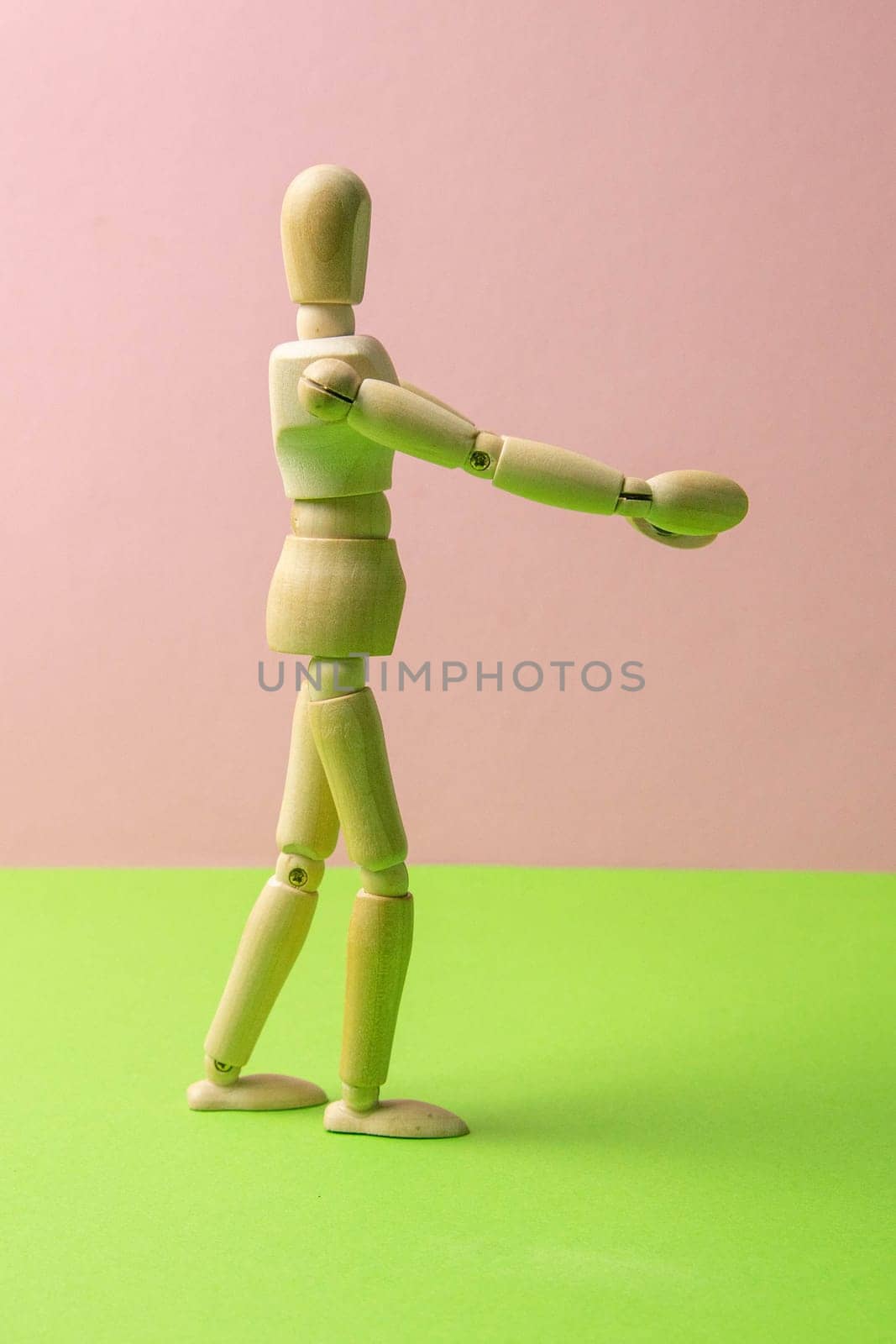 The figure of a wooden man stretches his arms forward, he wants to hug someone. The concept of loneliness, the need for attention. Close-up