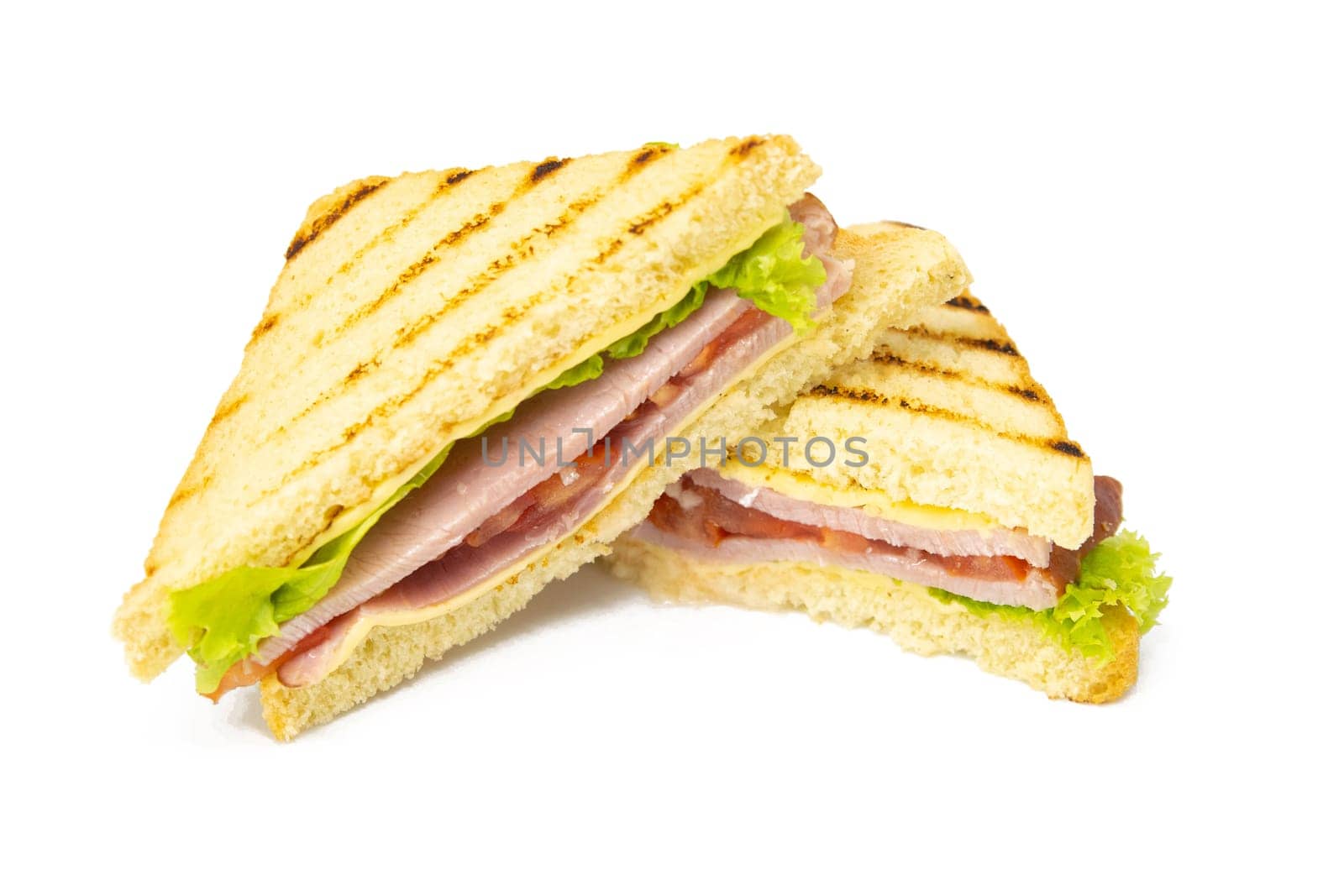 Sandwich with ham, cheese, tomatoes, lettuce, and toasted bread. Front view isolated on white background.